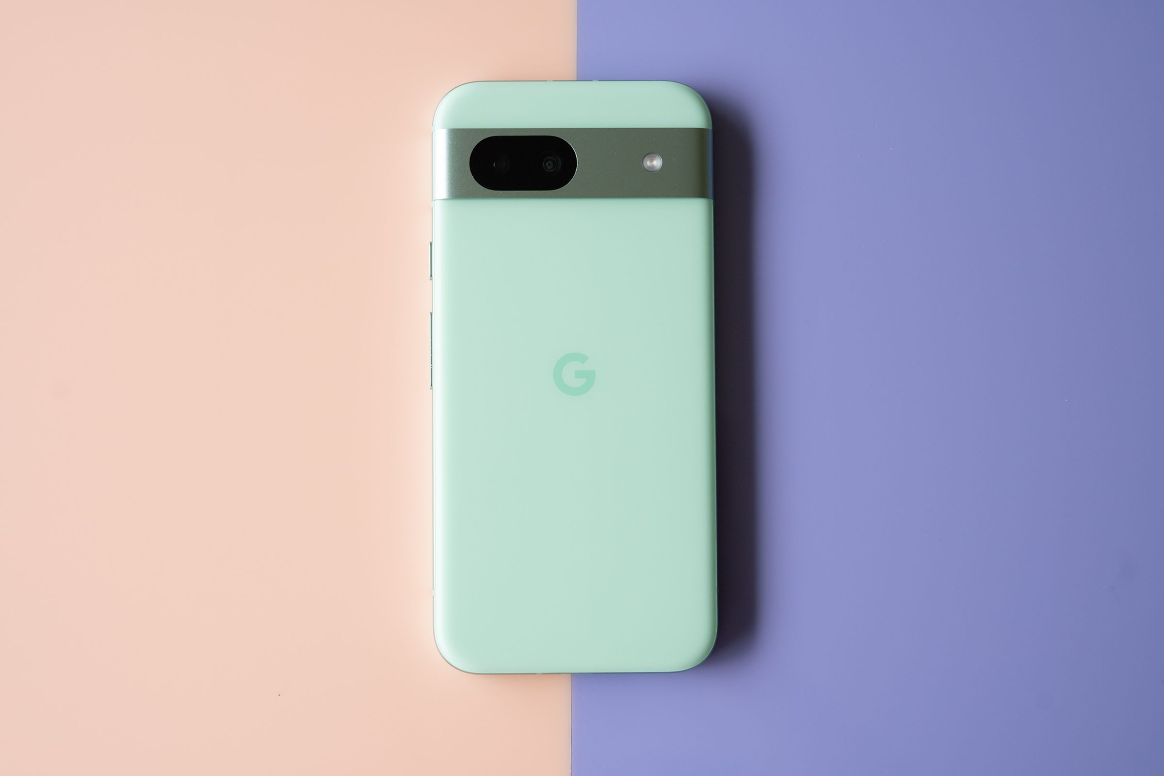 Google Pixel 8A in aloe green showing back panel.