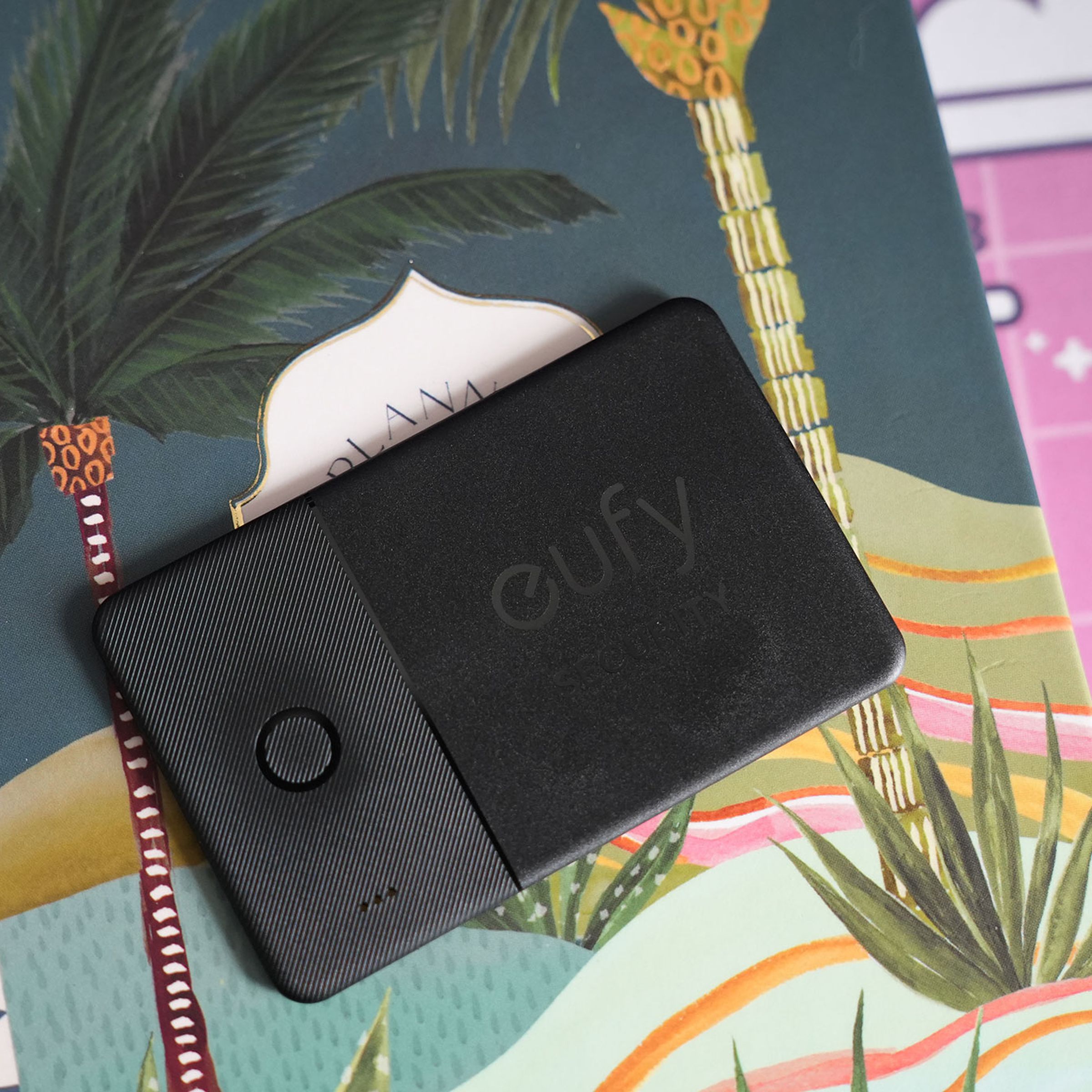 Eufy SmartTrack Card on top of a colorful notebook