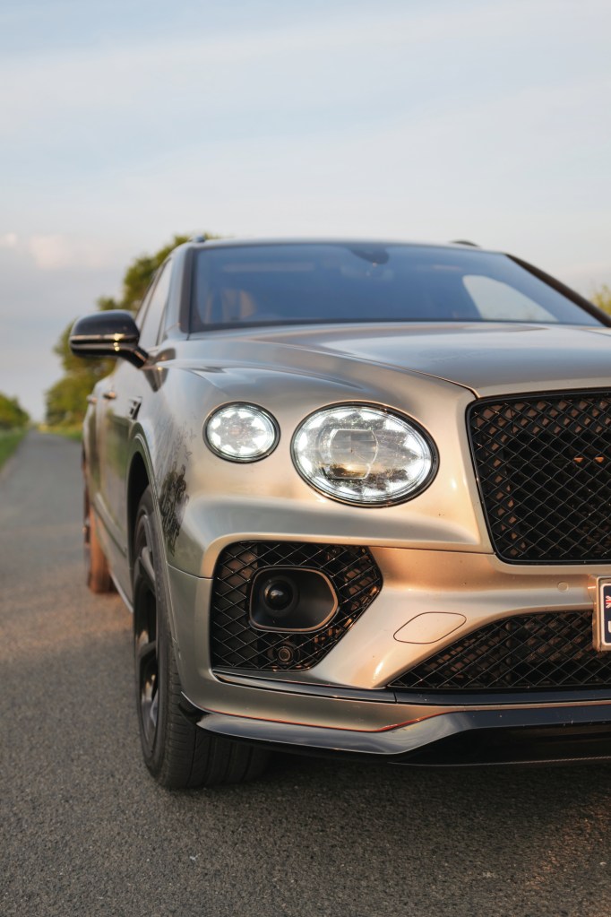 Green Bentley Bentayga on country road