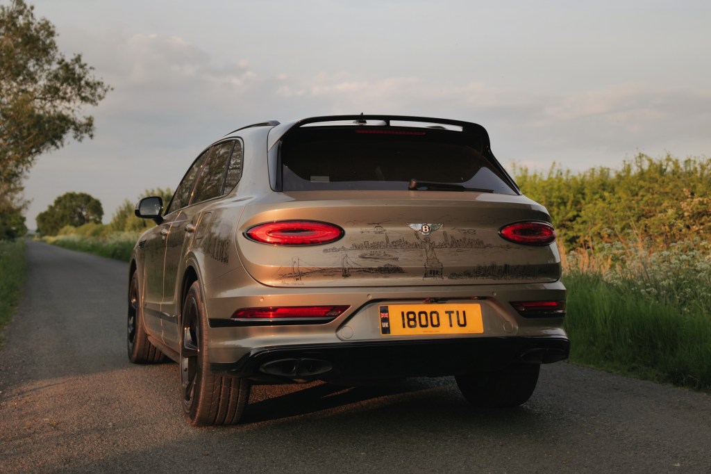 Green Bentley Bentayga on country road