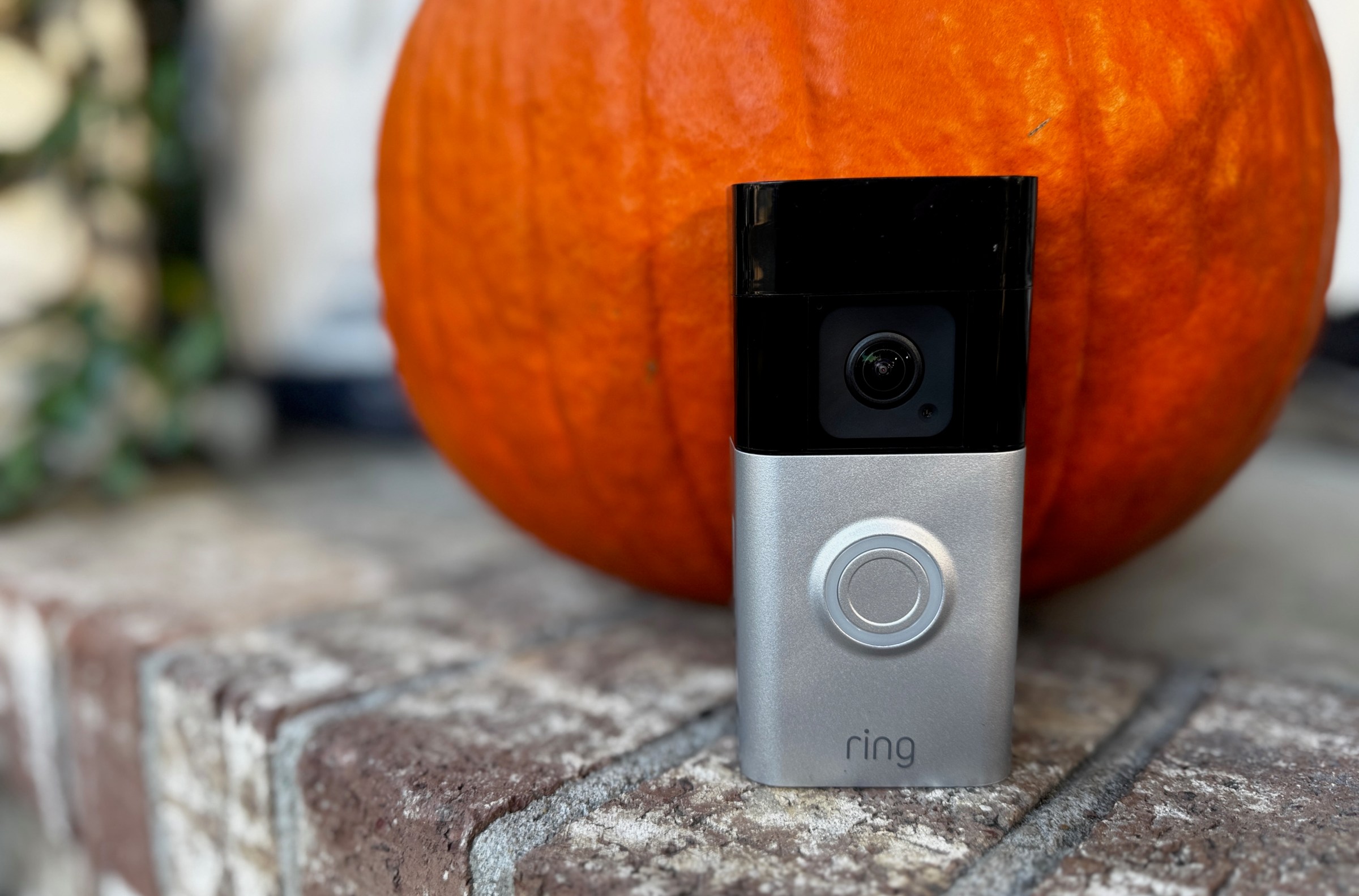 The Ring Battery Doorbell Pro in front of a pumpkin.