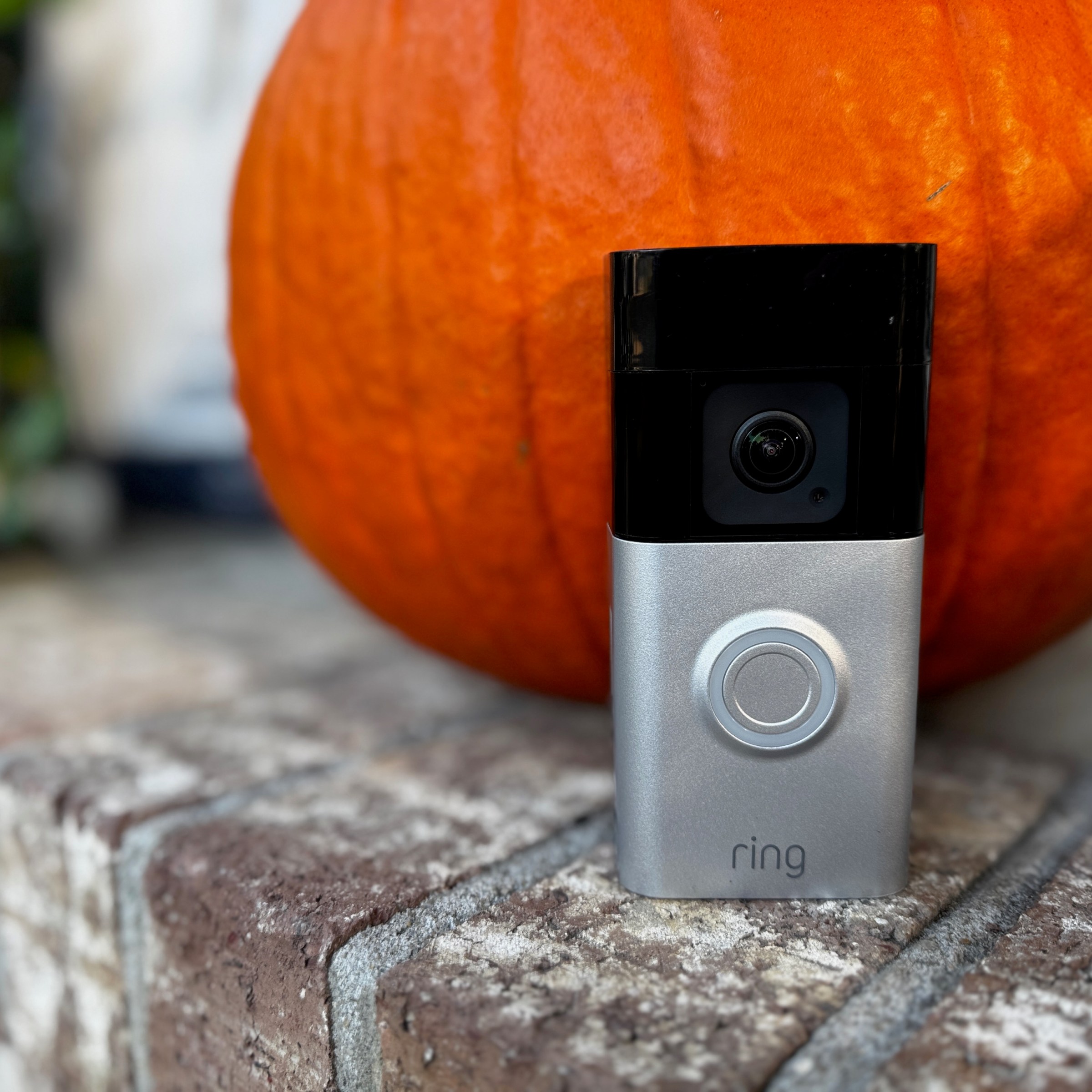 The Ring Battery Doorbell Pro in front of a pumpkin.