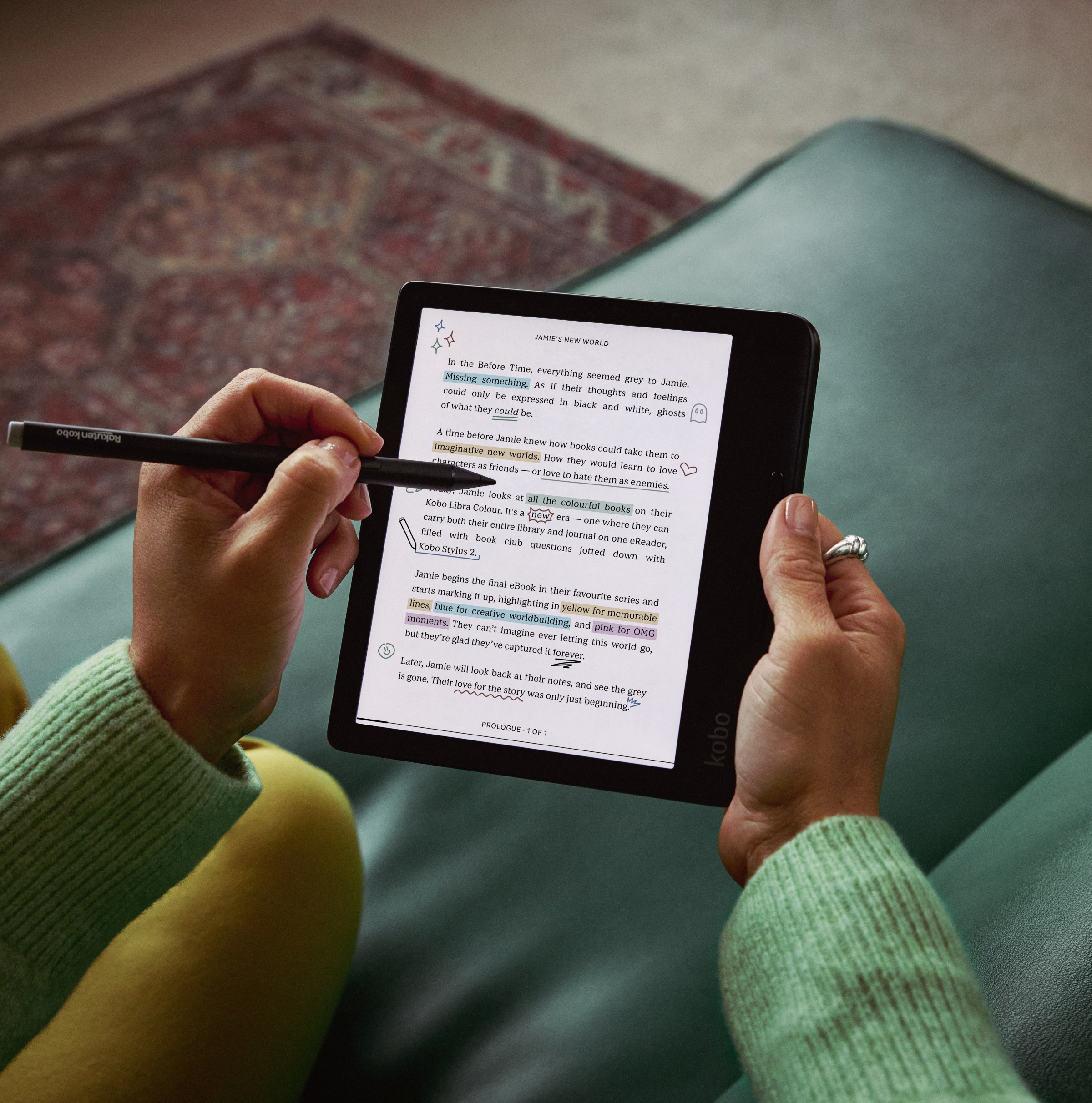 A hand using a stylus to take notes on the Kobo Libra Colour e-reader.