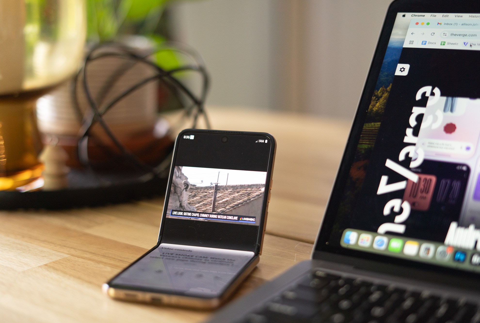 Photo of Motorola Razr Ultra on a table with inner screen folded halfway.
