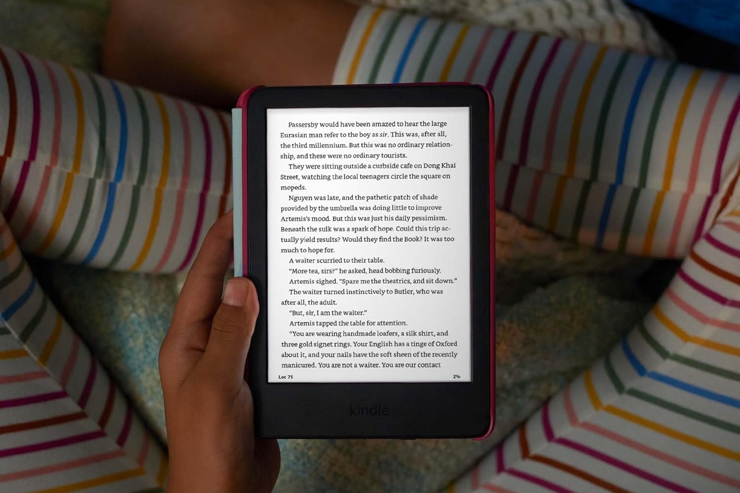 A person holding the kid-friendly Kindle in their lap.