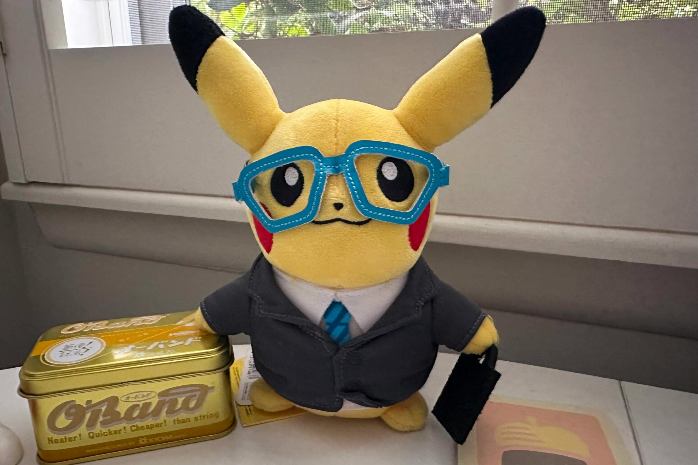 A Pikachu in a suit and a blue Poliwhirl fan.
