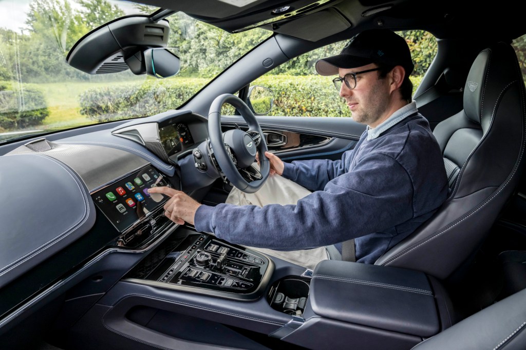 Author sitting in a car using Apple CarPlay Ultra display