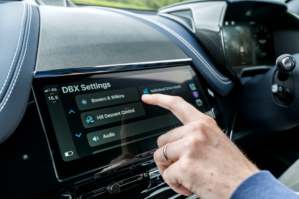 Finger pointing to Apple CarPlay Ultra display