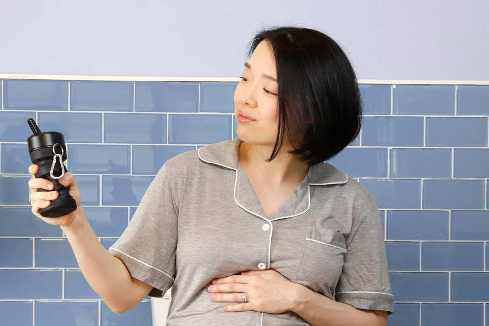 A woman holding a portable bidet.