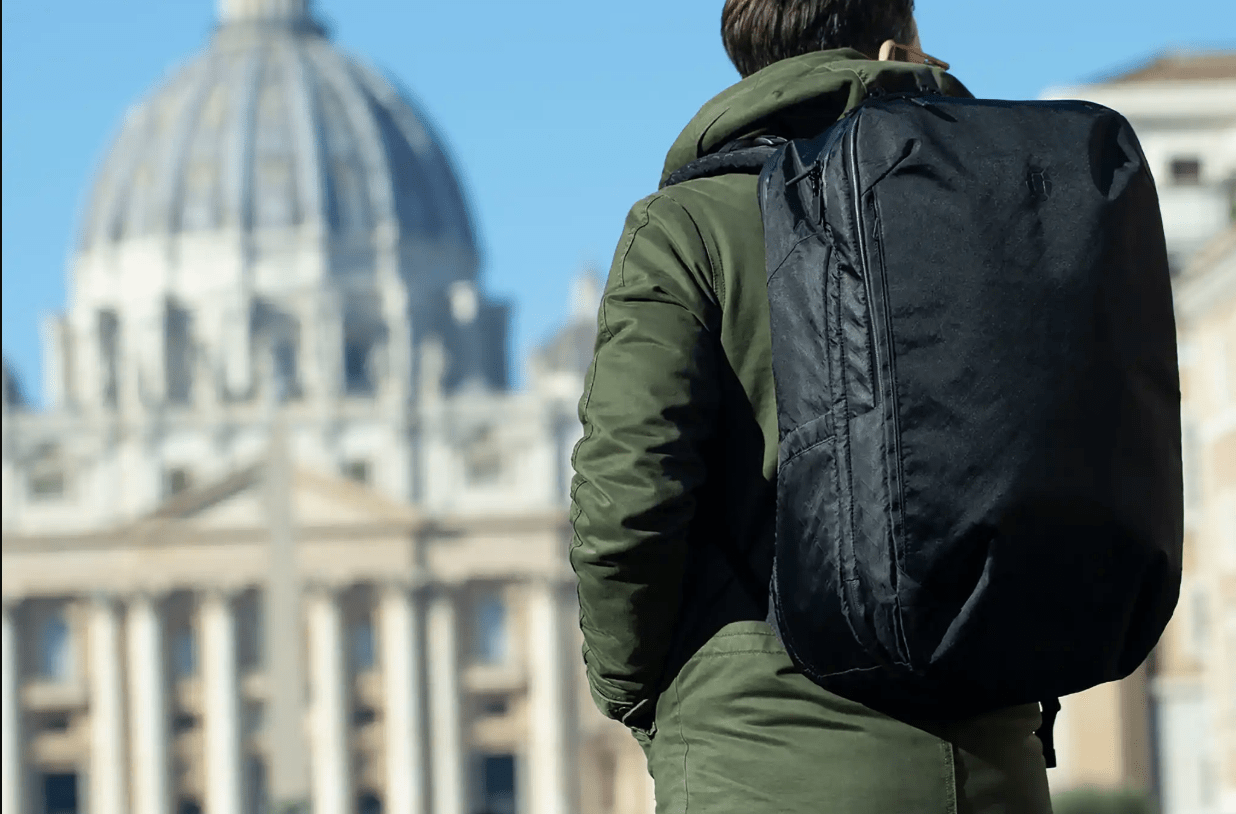 Person with backpack facing a capital building.