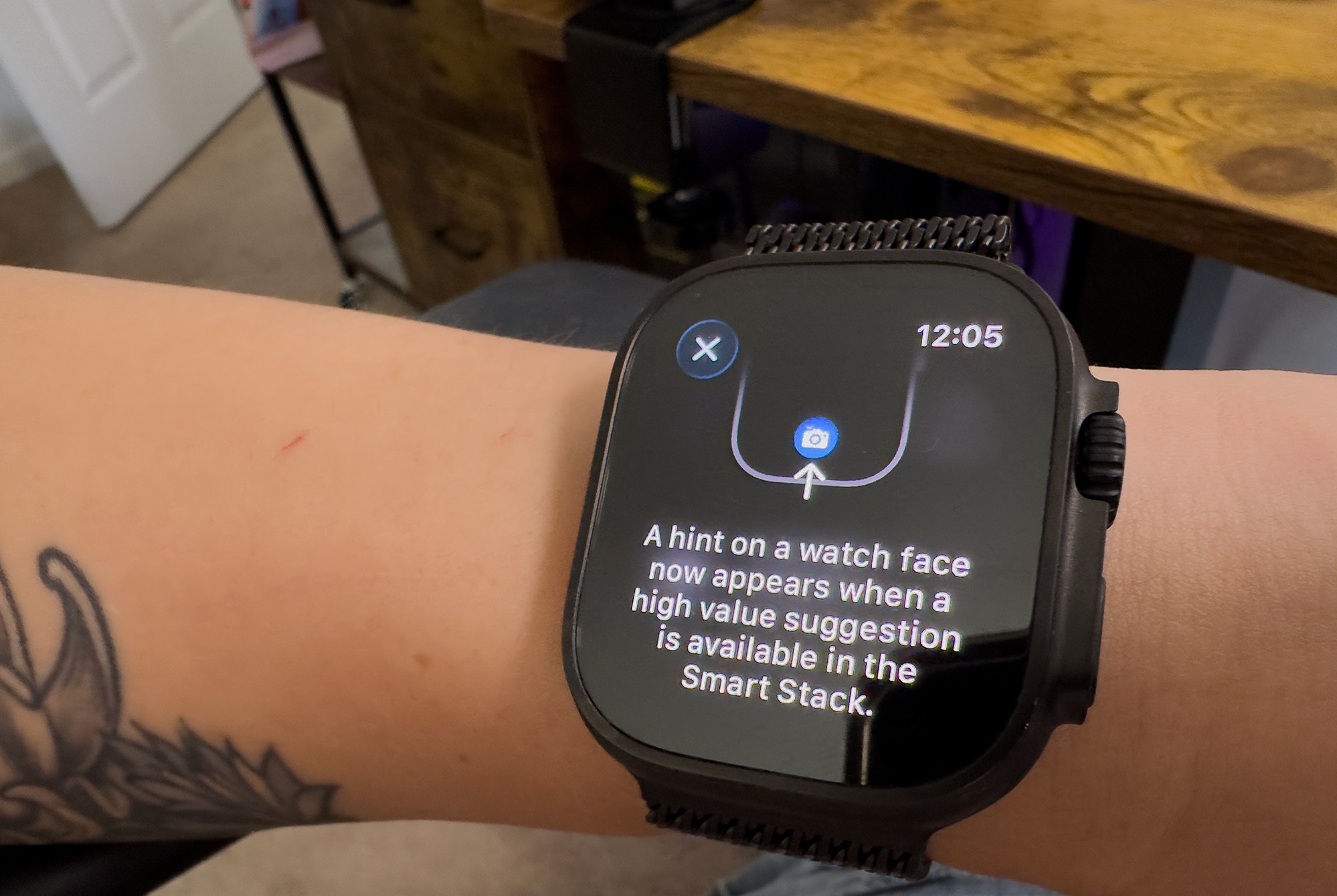 close up of watchOS 26 showing where a Smart stack icon will appear with the words “A hitn on a watch face now appears when a high value suggestion is available in the smart stack.