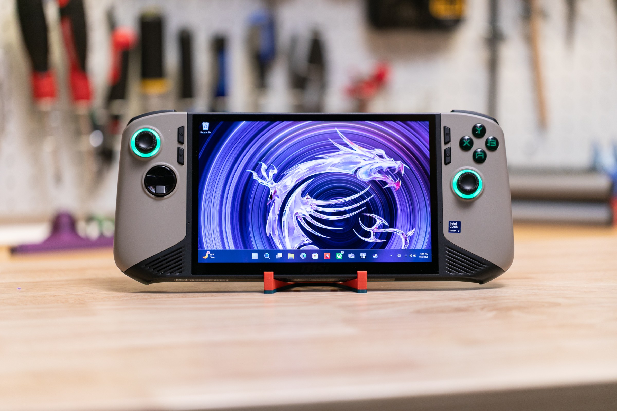 The MSI Claw 8 AI Plus at a distance: it’s a gaming handheld PC in grey with black trim and LED lit joysticks.