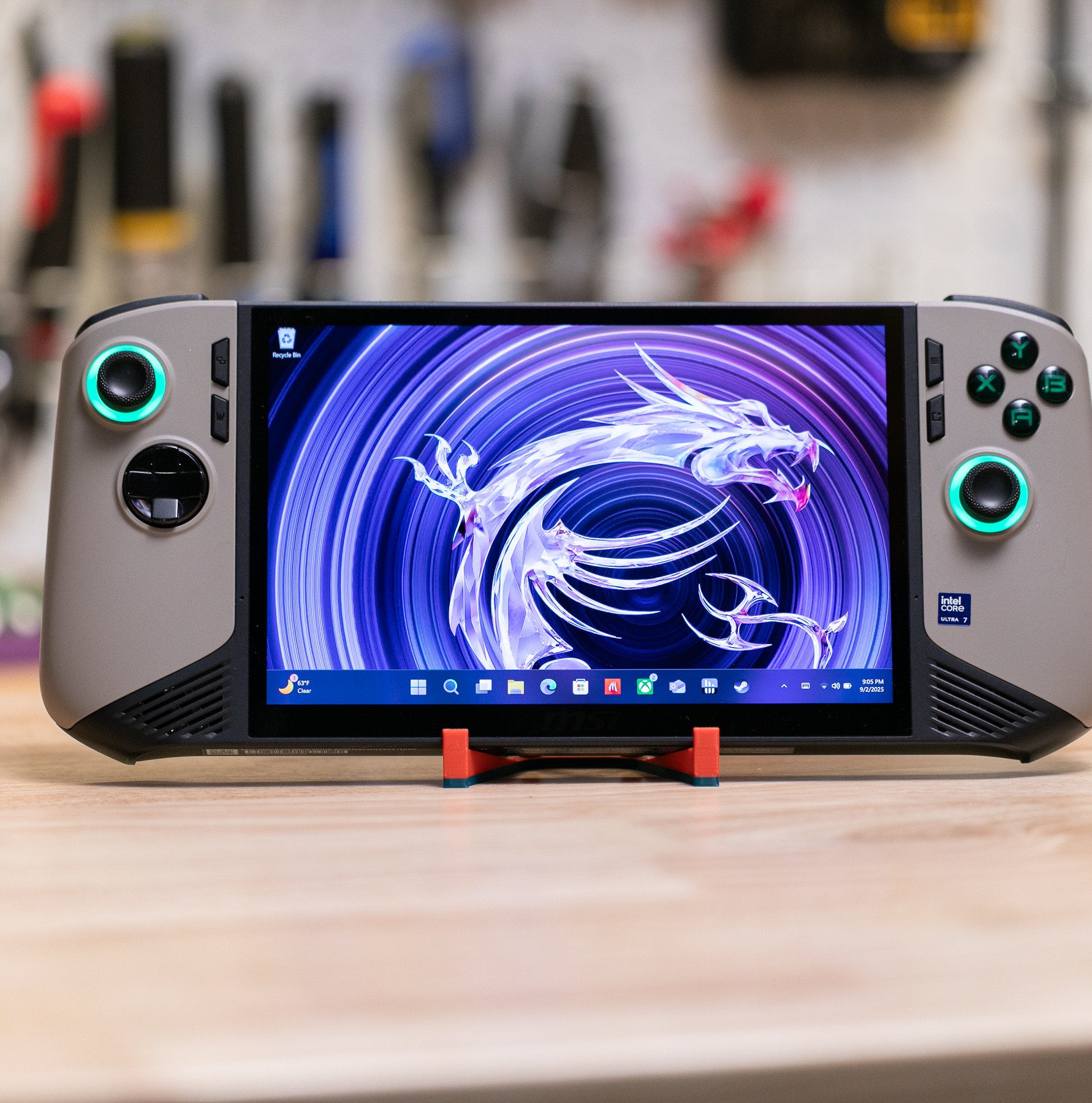 The MSI Claw 8 AI Plus at a distance: it’s a gaming handheld PC in grey with black trim and LED lit joysticks.
