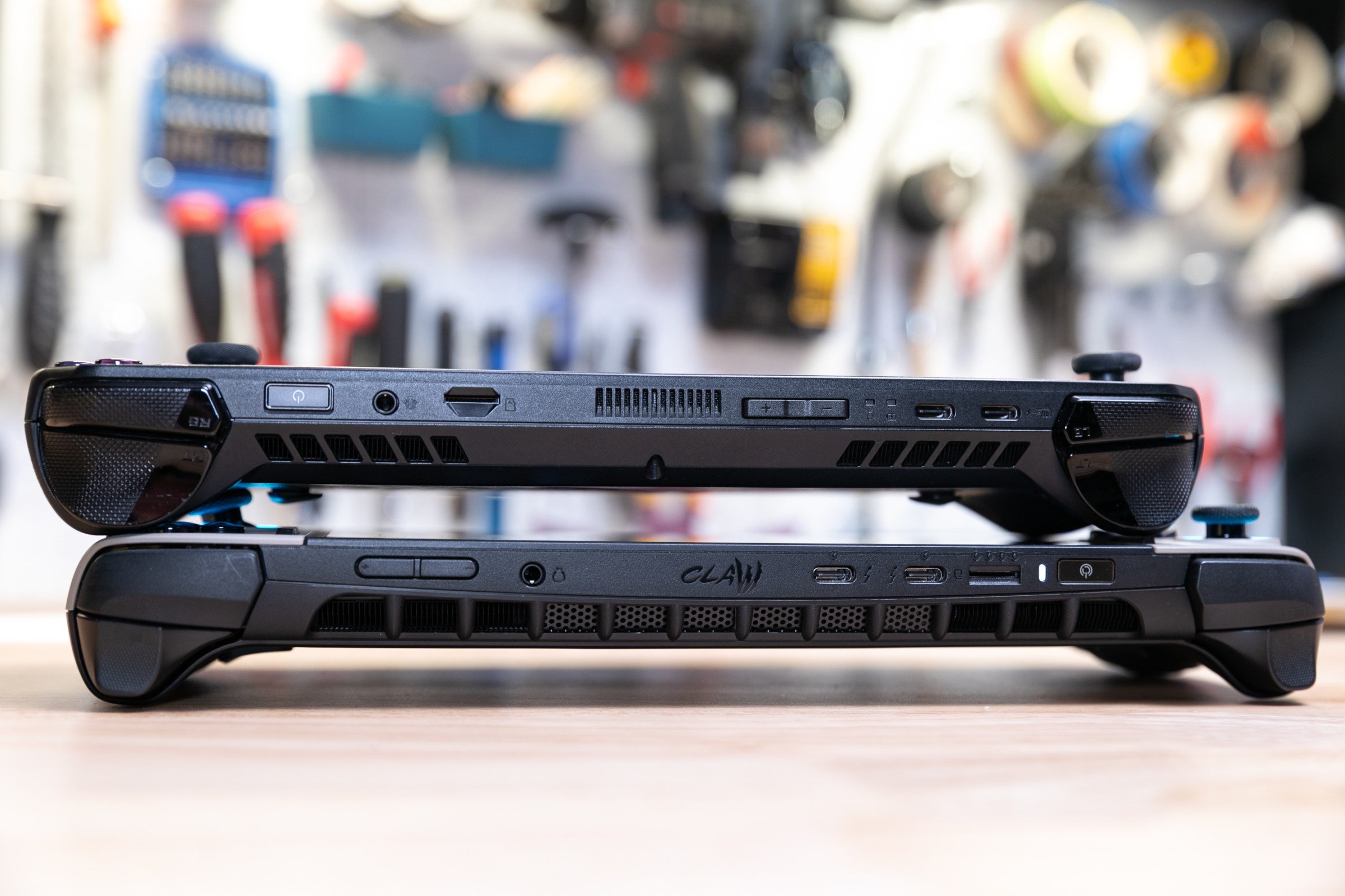 A port comparison between the MSI Claw 8 AI Plus and ROG Ally X, showing similar pairs of USB-C ports, fingerprint reader, SD card slot, all on top edge.