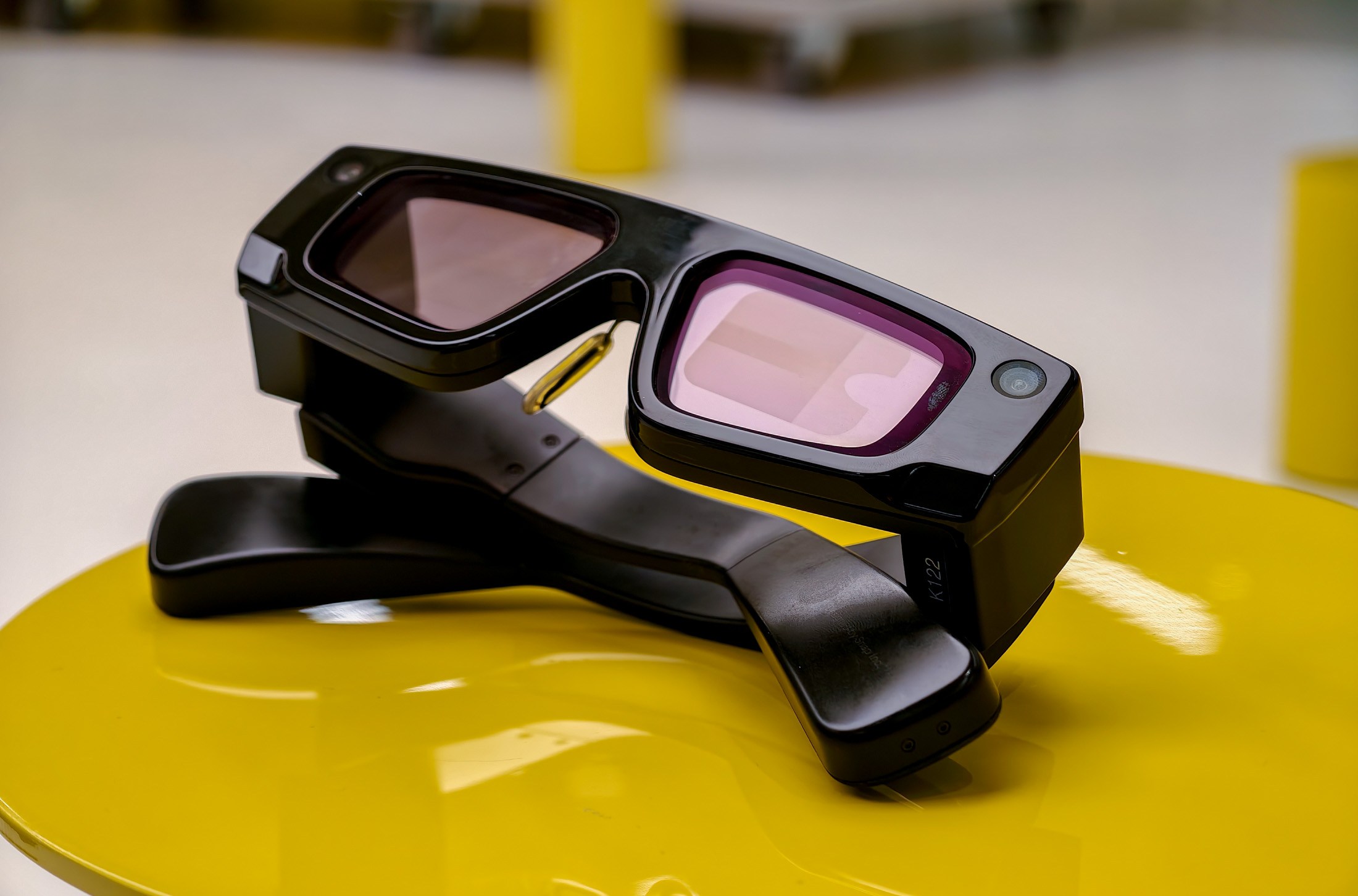 Snapchat’s developer-only Spectacles lying on a yellow table