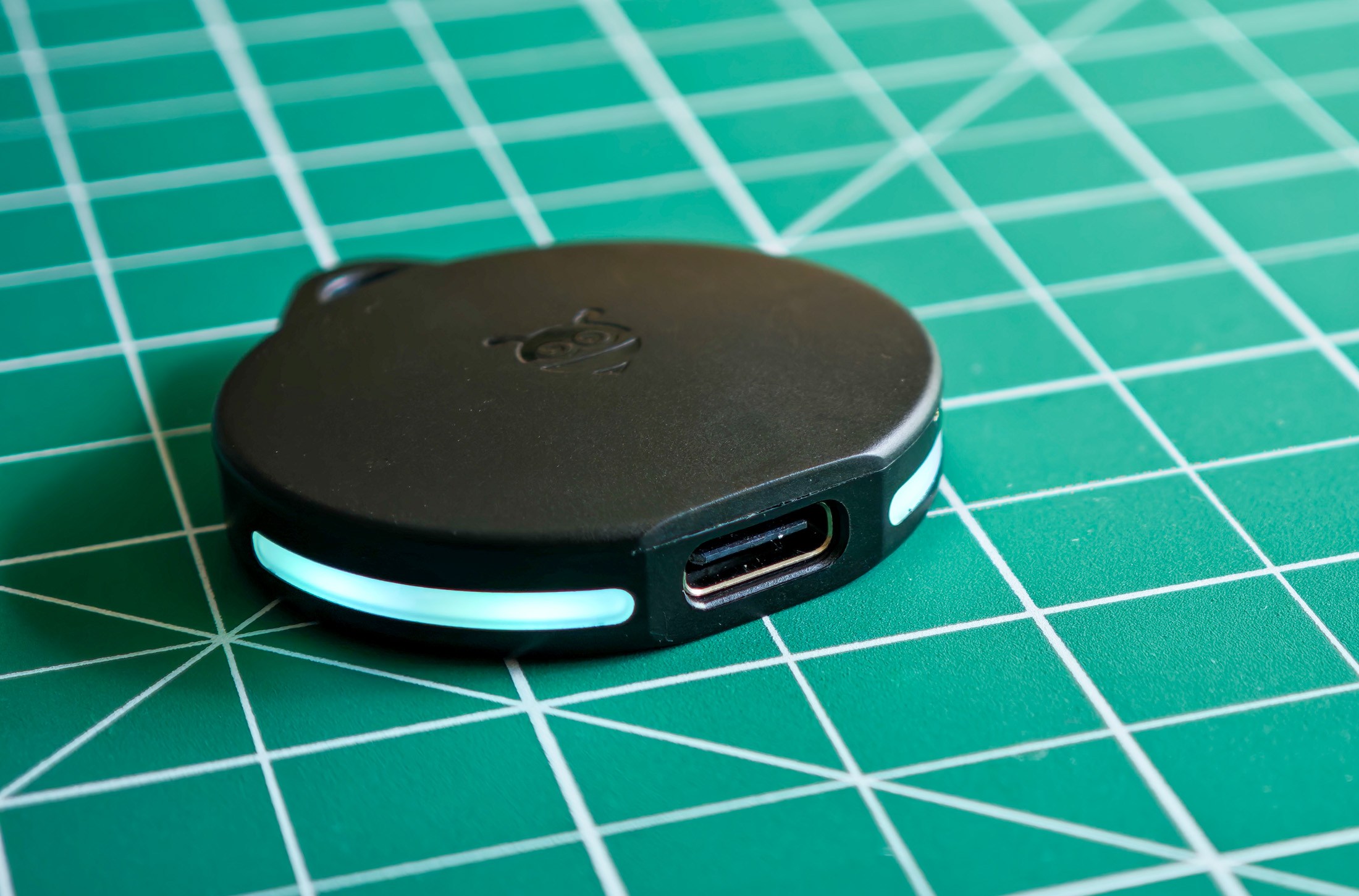 A Pebblebee Clip tracker with the light on