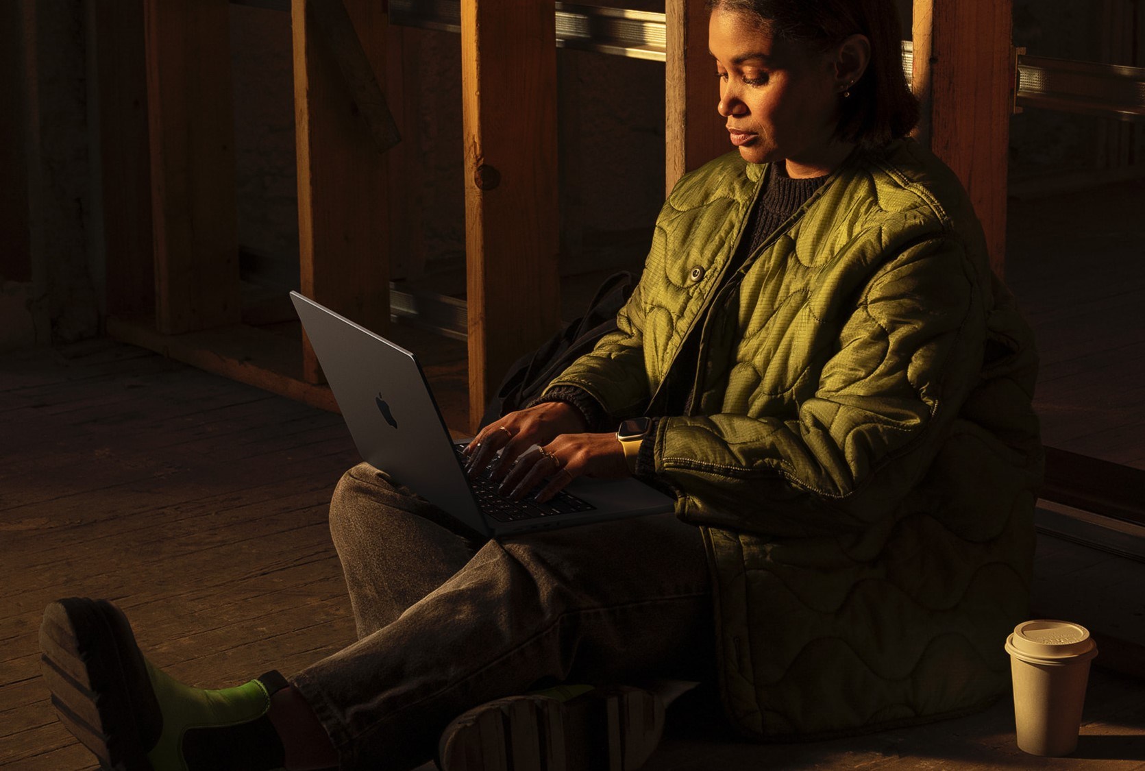 Someone sitting on ground using MacBook Pro