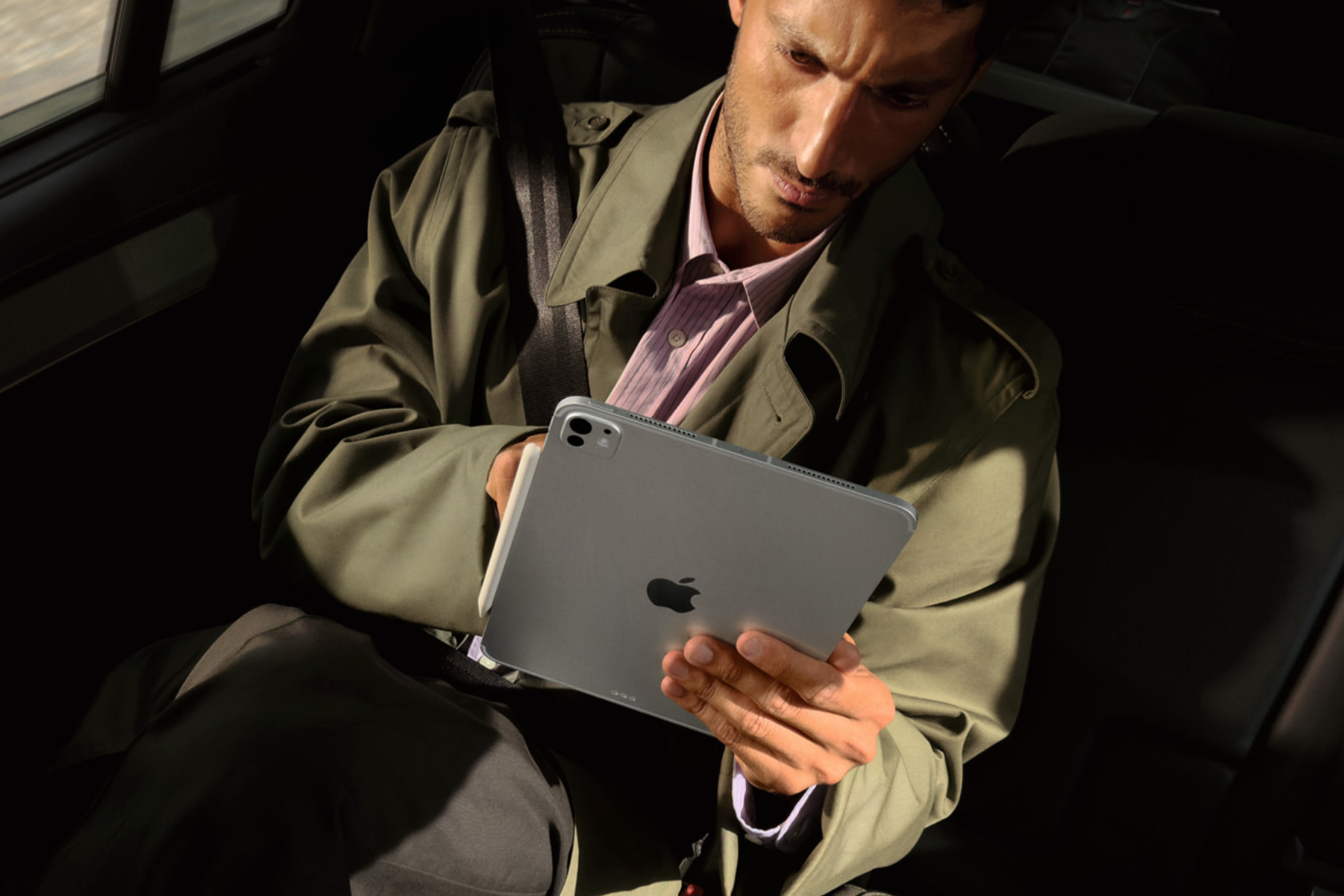 Apple's M5 iPad Pro being used by a man in a car.
