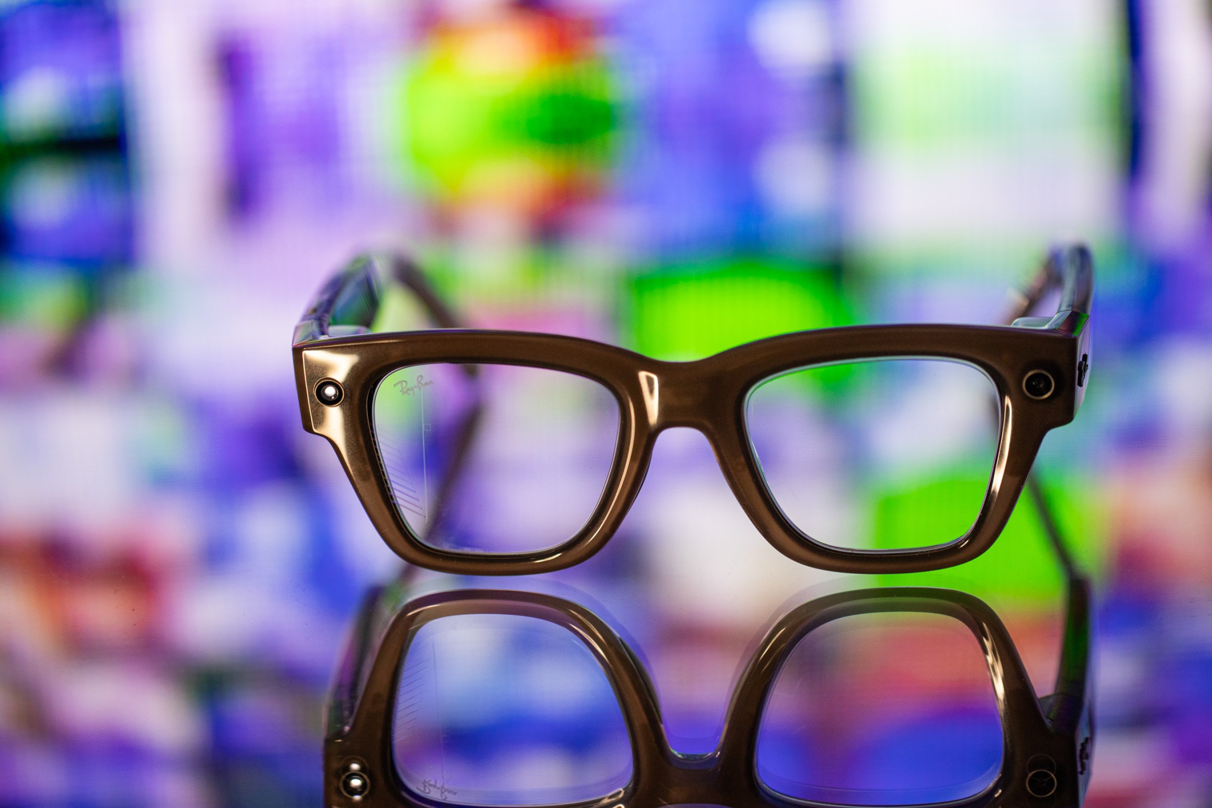Close up of Meta Ray-Ban Display with a mosaic of TV static behind it.