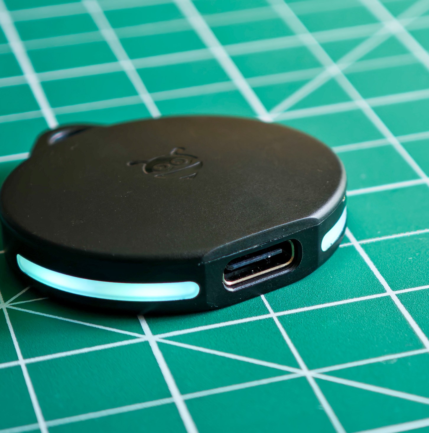 A Pebblebee Clip tracker with the light on