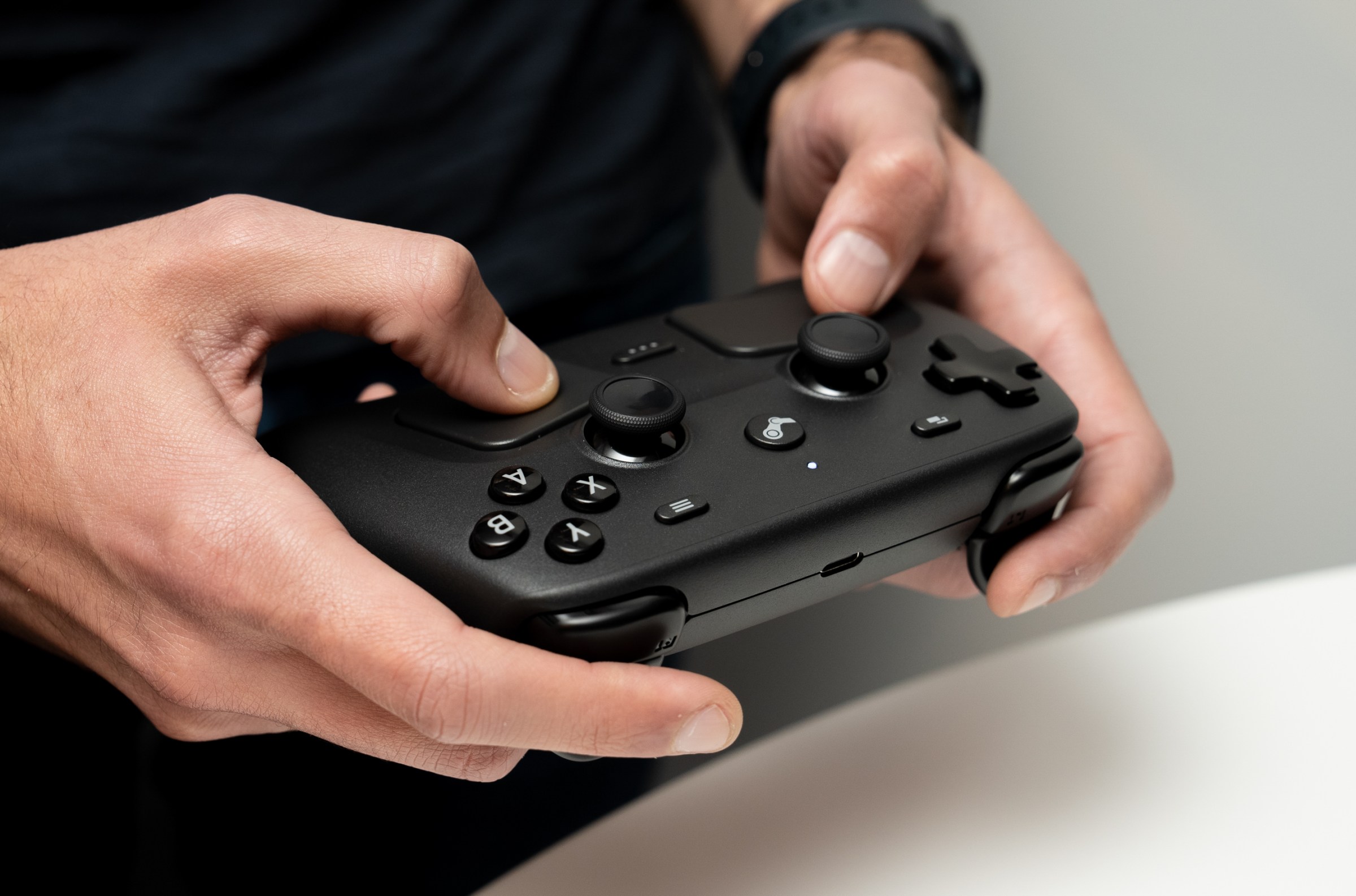 The Verge’s Jay Peters holding Valve’s Steam Controller.