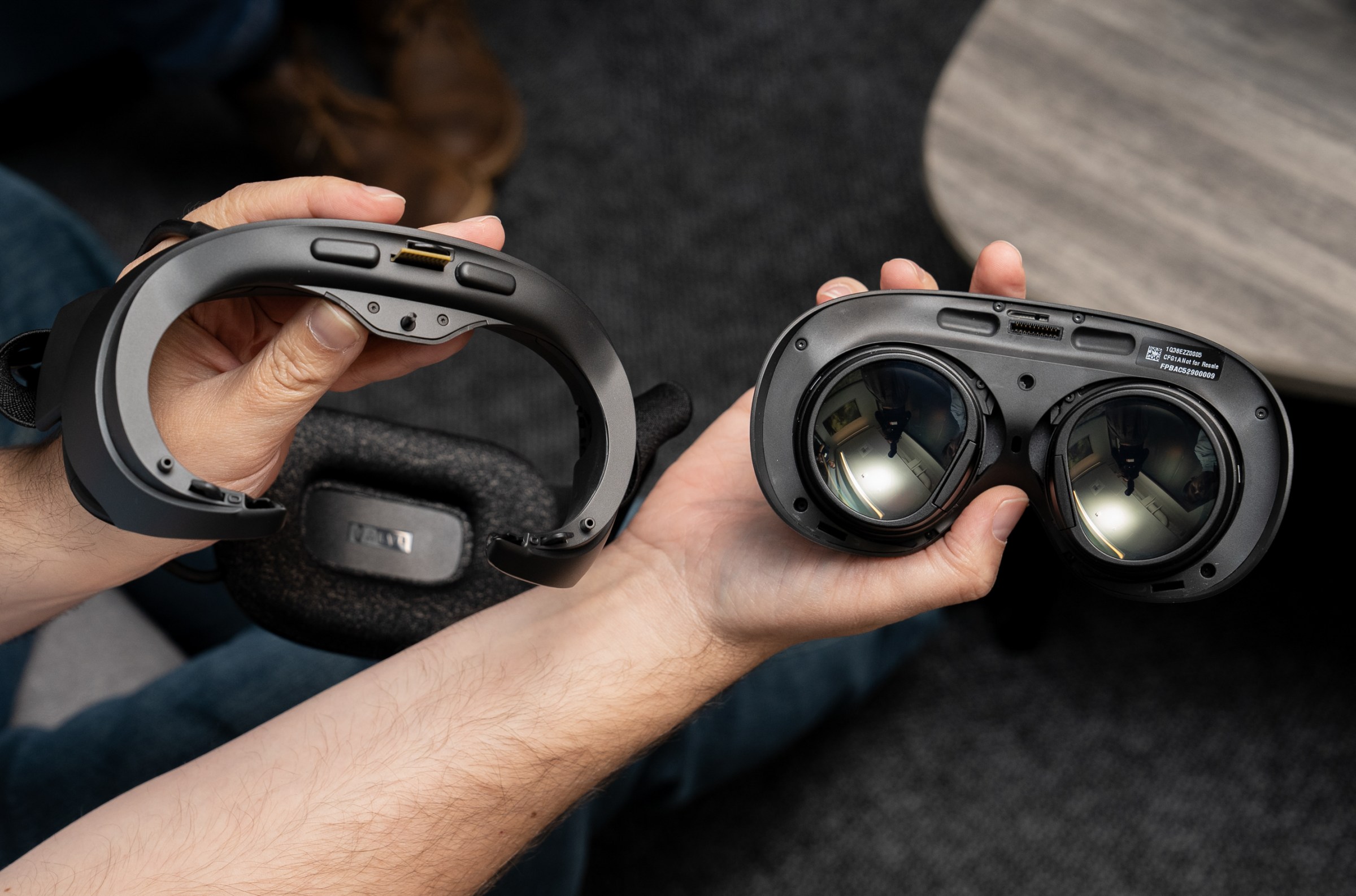 A person holding the Steam Frame with the headband removed.