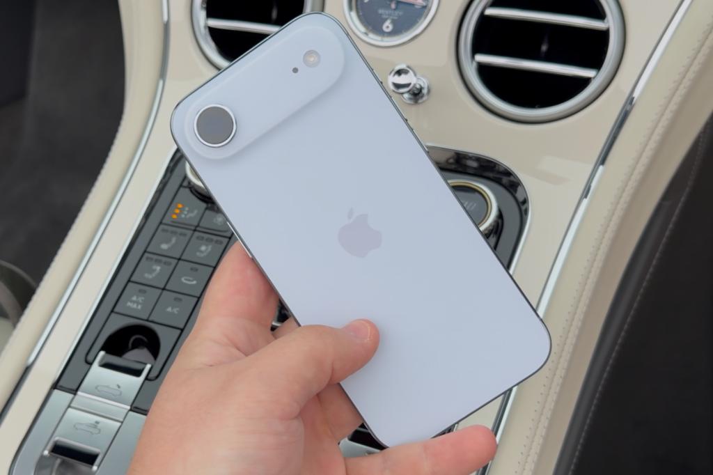 iPhone Air being held diagnonally in a Bentley