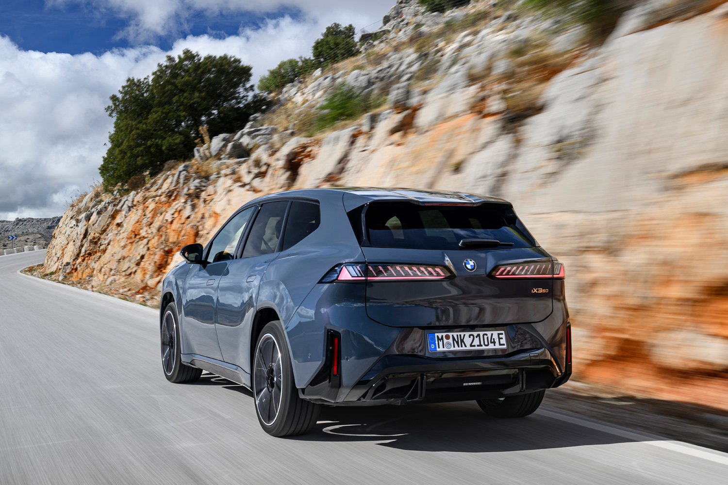 BMW iX3 2026 drive on road rear