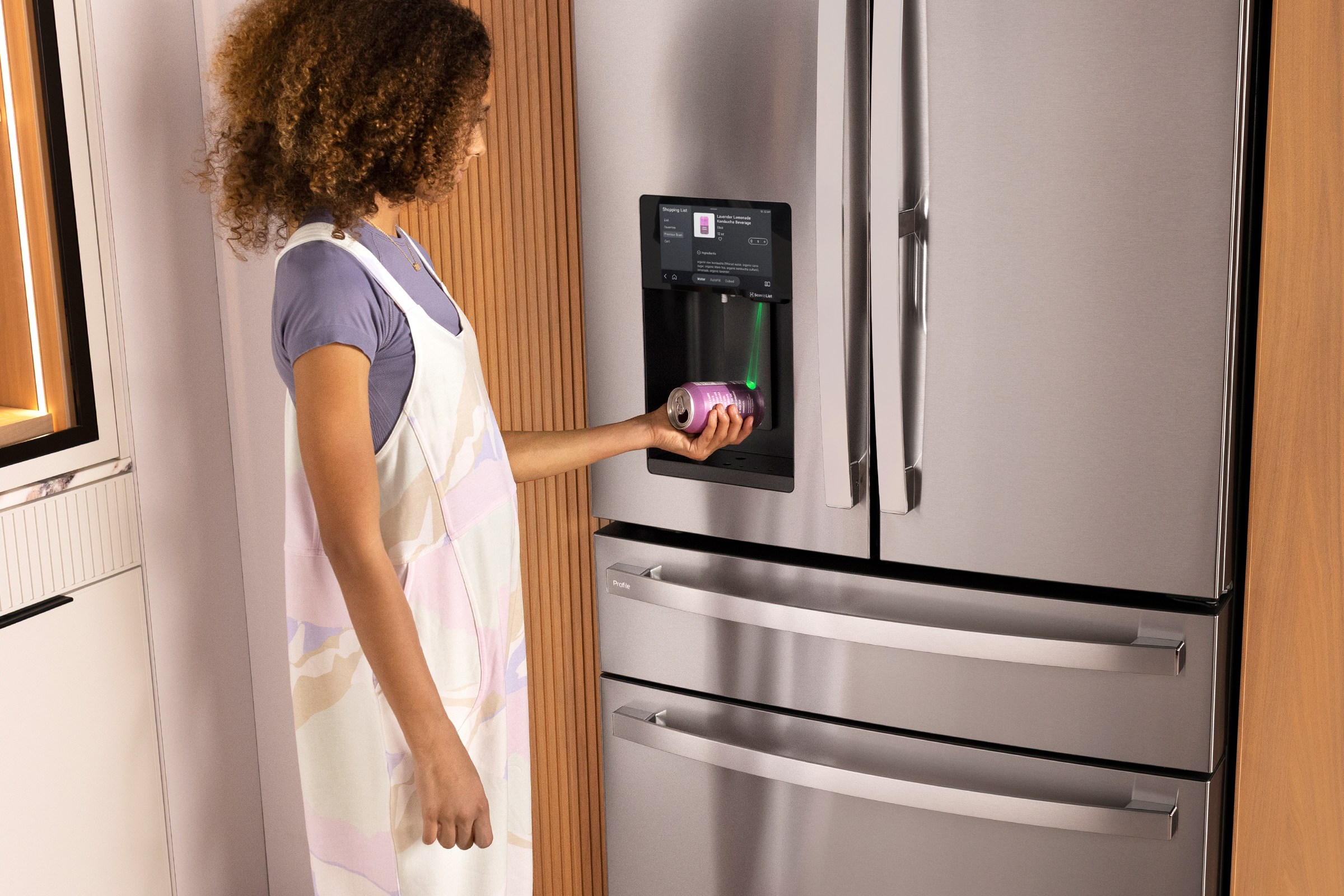 A person scans an empty soda can using the GE Profile Smart 4-Door French-Door Refrigerator with Kitchen Assistant.