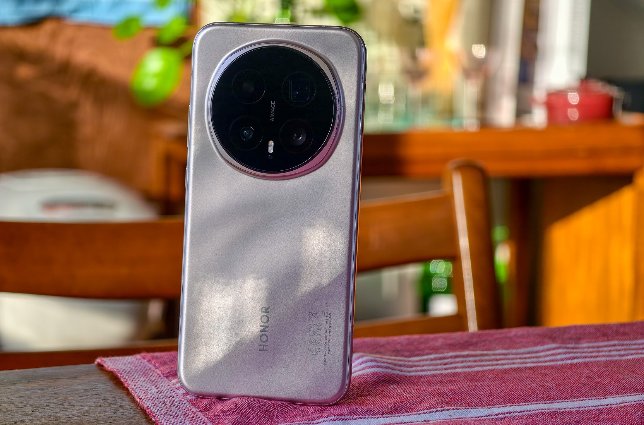 Photo of Honor Magic 8 Pro on a wooden table showing the back of the phone