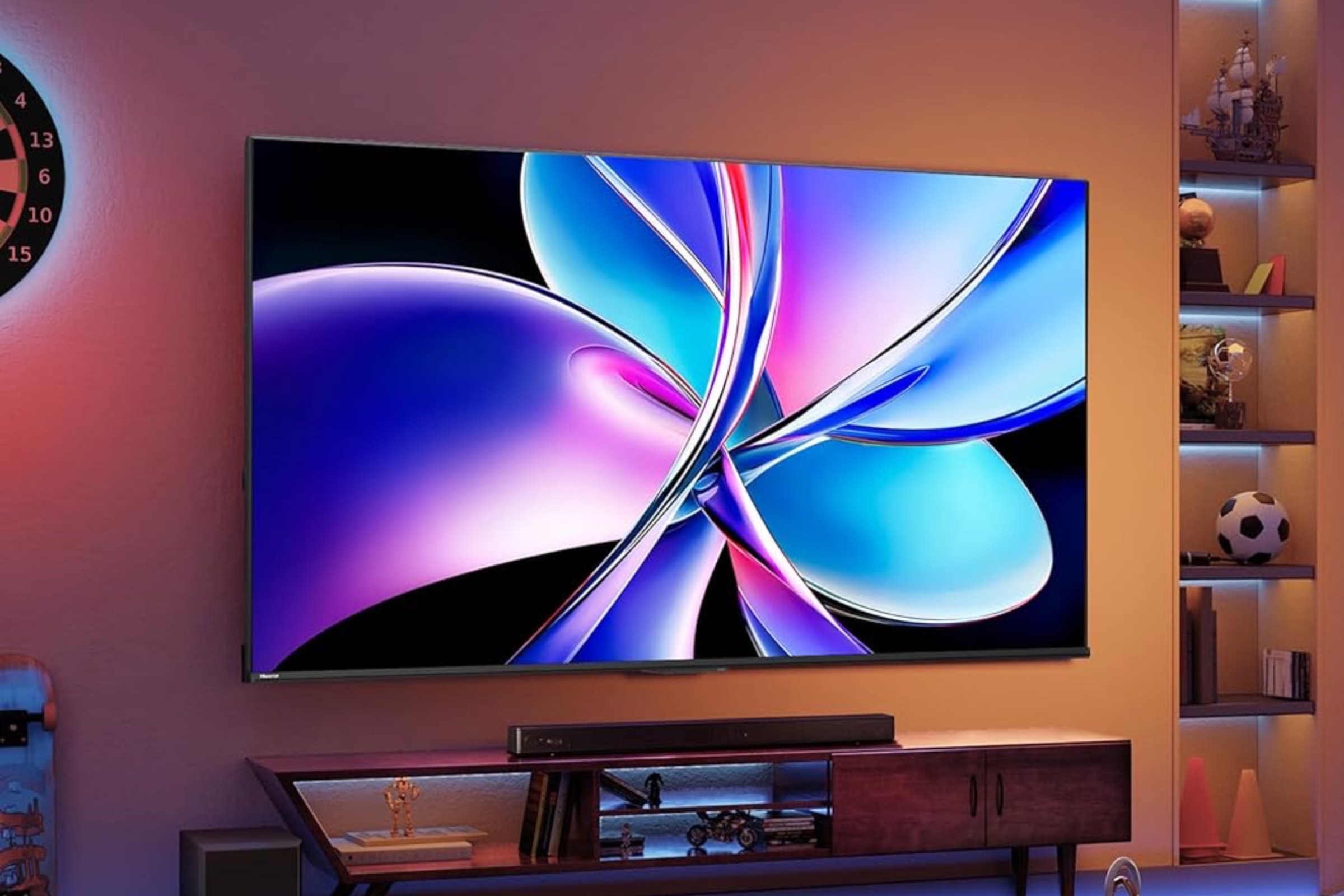 Hisense’s QD7 4K TV mounted onto a wall above a sound bar and media center.