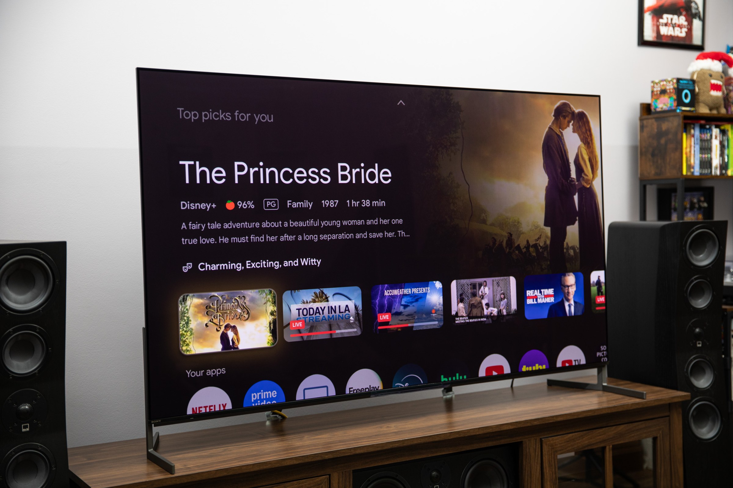 The Sony Bravia 8 II TV on a wooden TV stand displaying the Google OS home page.