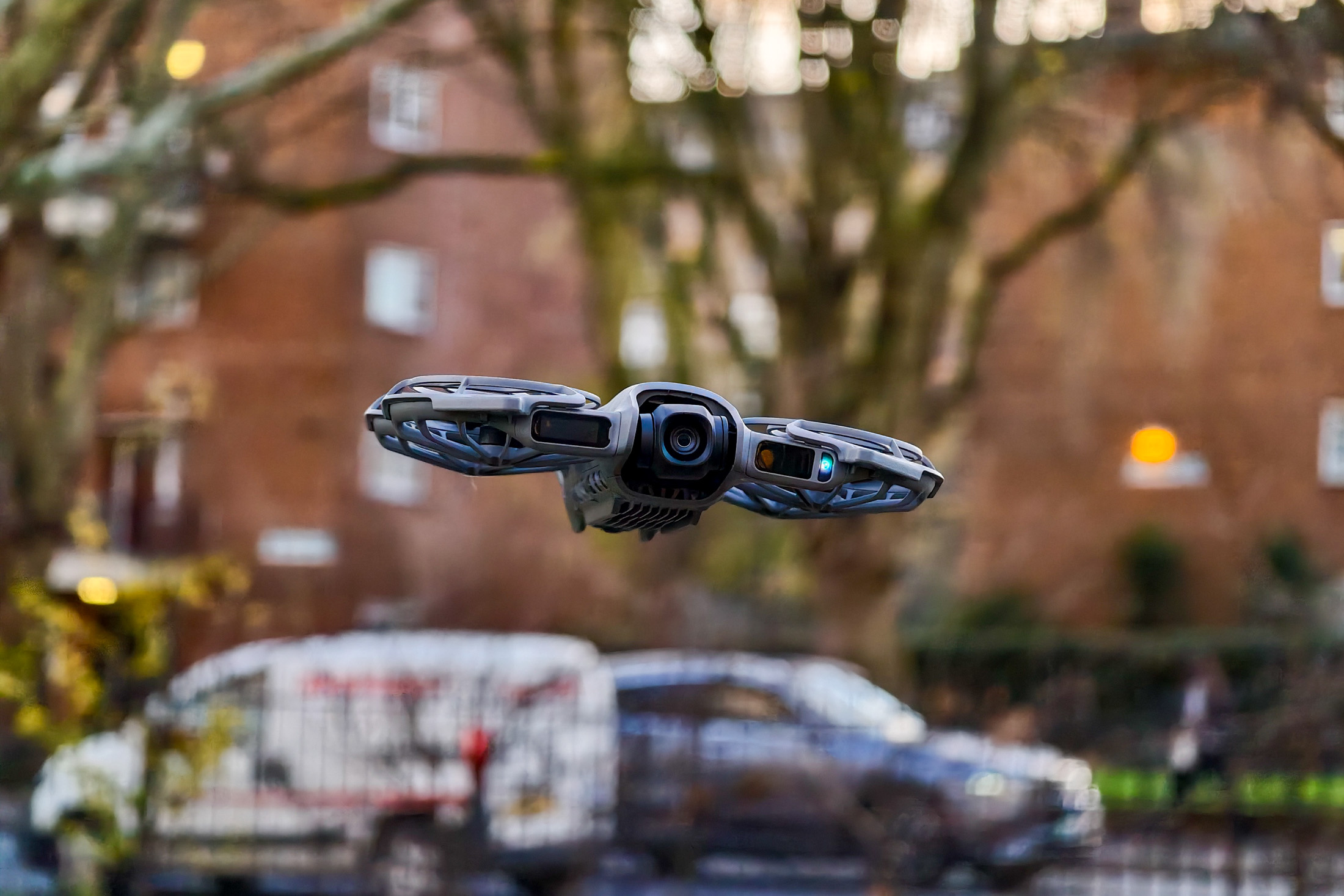 Photo of DJI Neo 2 hovering in front of a road