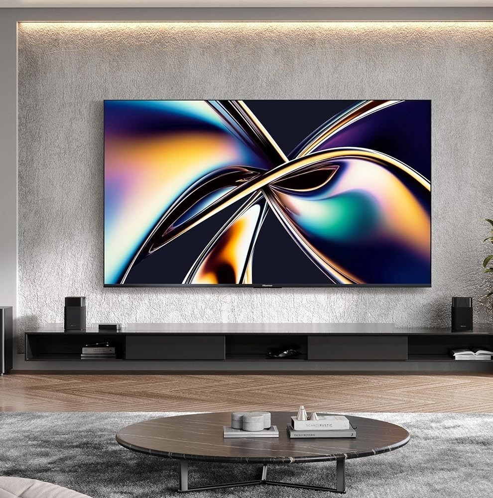 Hisense’s U65QF 4K TV mounted on a wall above a media center in a living room.