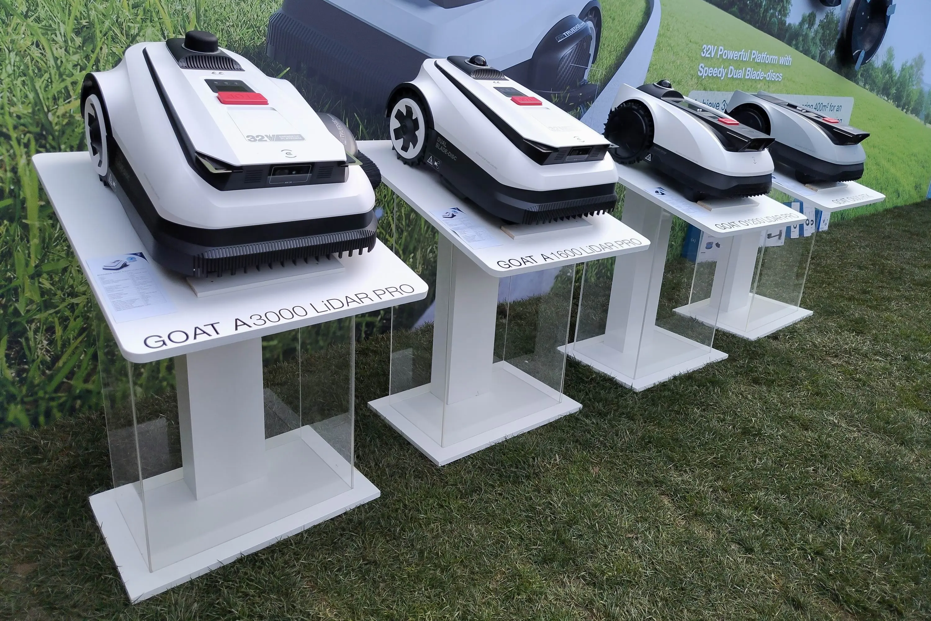 A row of four robot lawnmowers