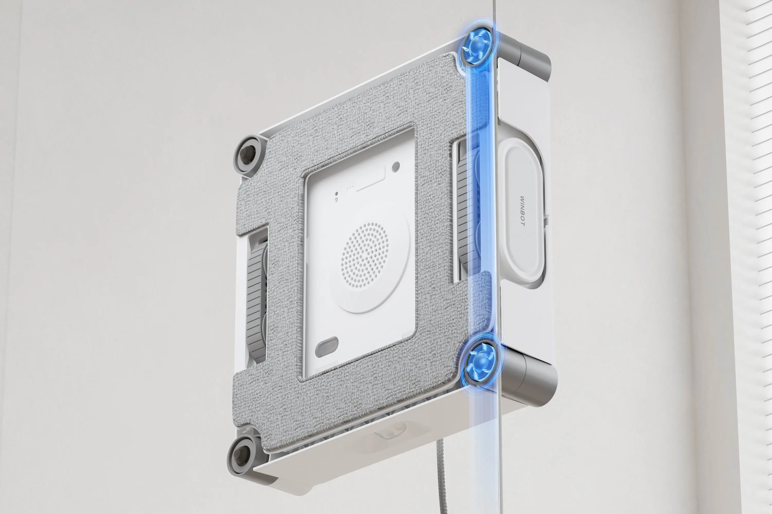 A robot window cleaner seen from the underside, so you can see how it gets up to the window's edges