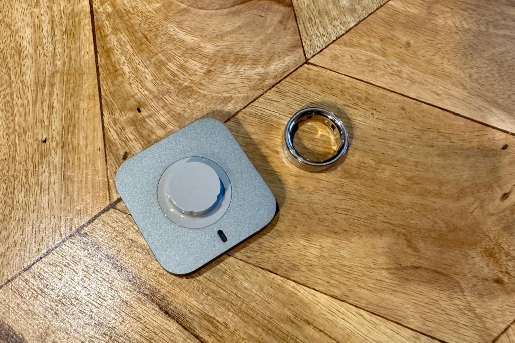 Oura Ring 4 on table next to charger
