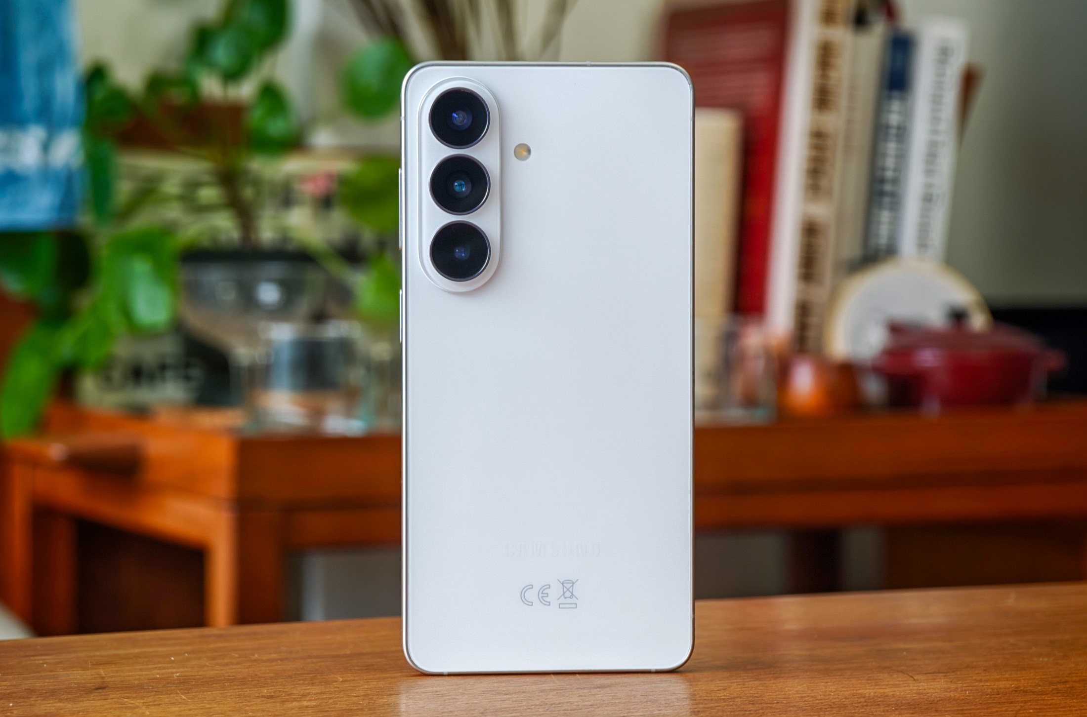 Photo of white Samsung Galaxy S26 on a wooden table