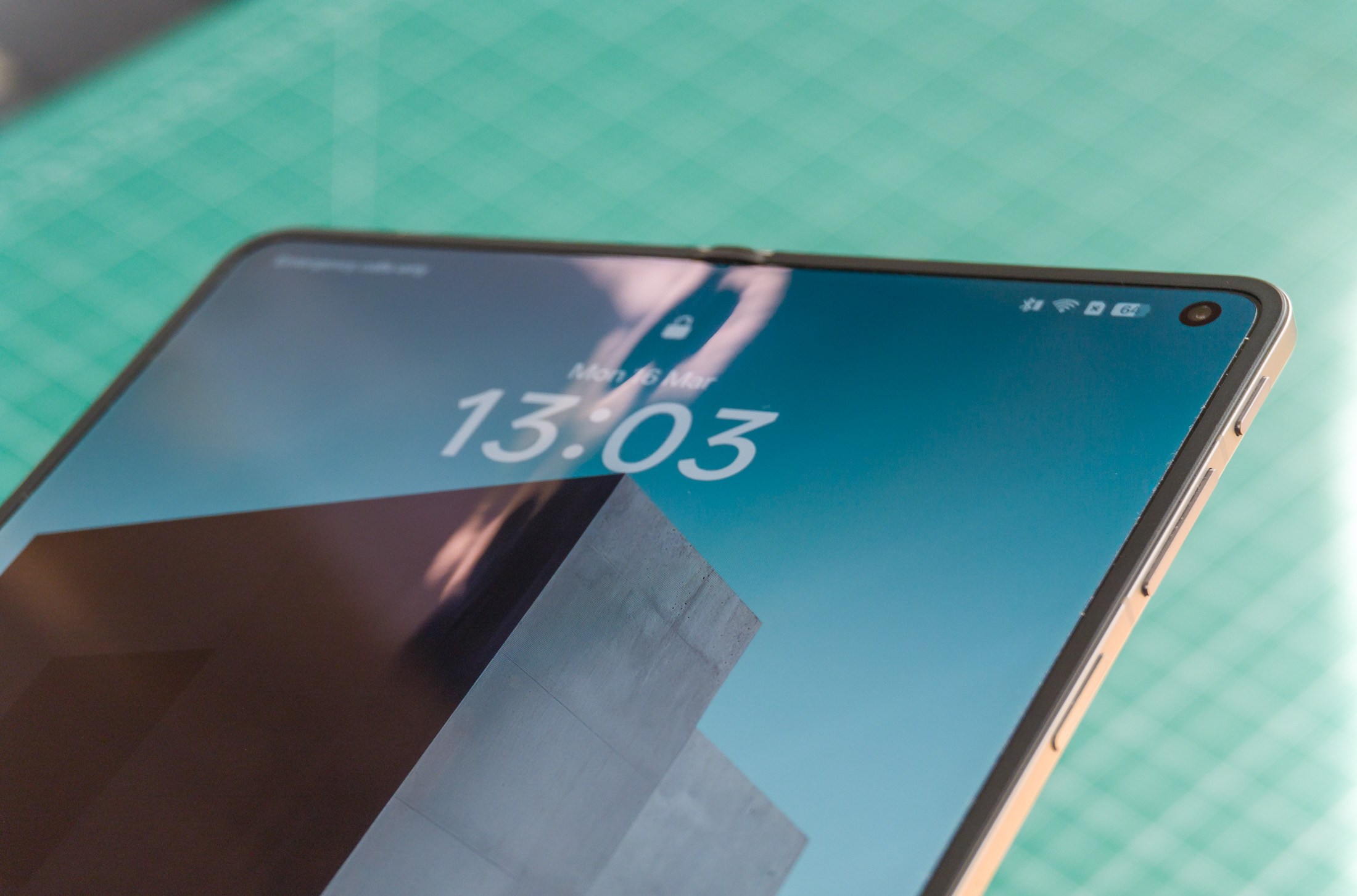 Photo of Oppo Find N6 above a green work mat with the screen on centered on the crease, which is visible in the light