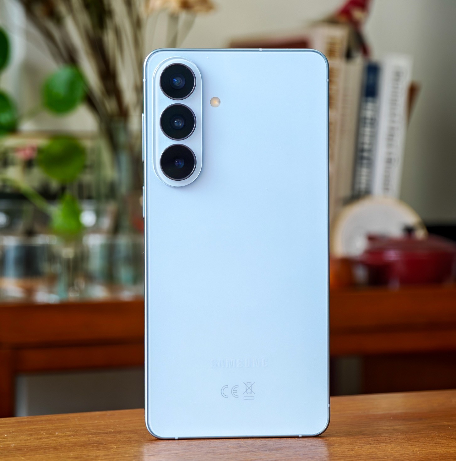 Photo of blue Samsung Galaxy S26 Plus on a wooden table