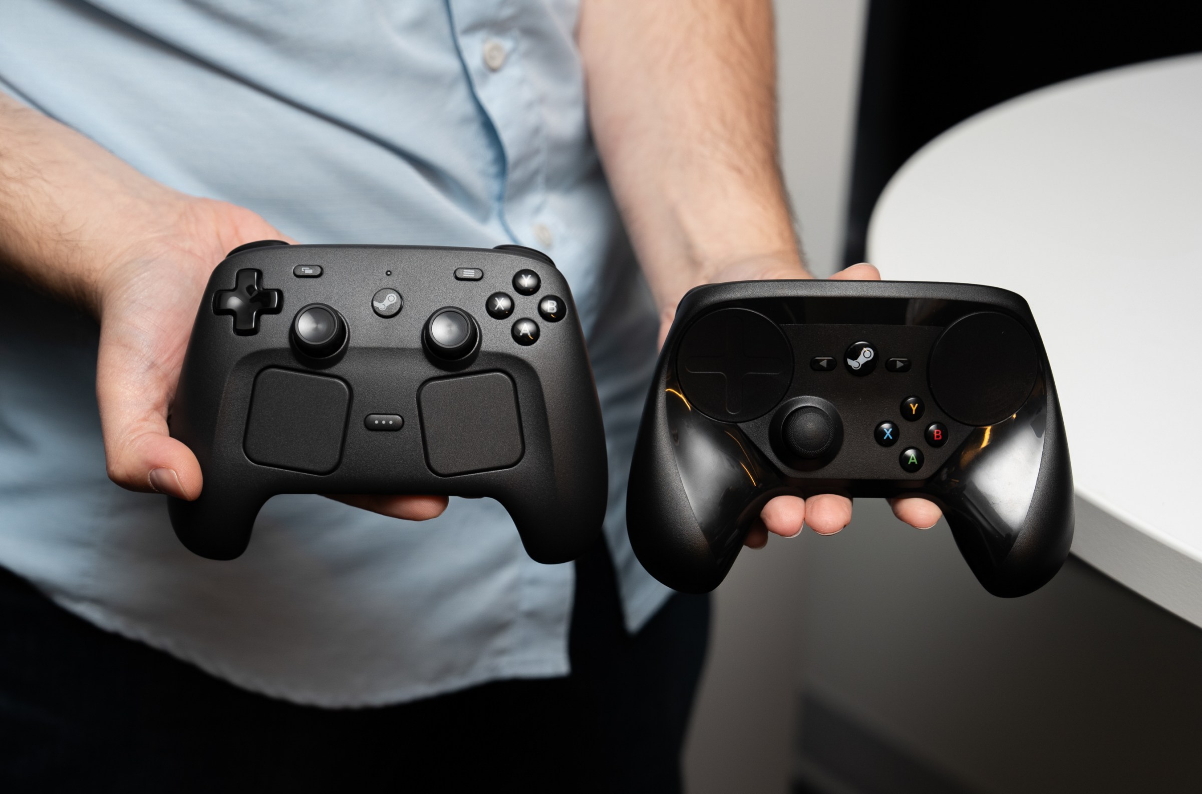 Valve’s second-generation Steam Controller next to its first-generation Steam Controller.