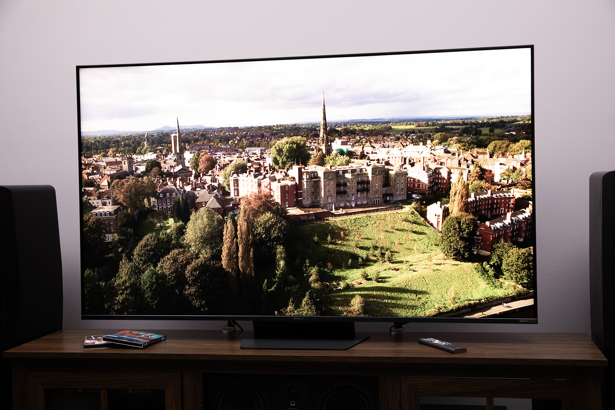 Hisense UR9 RGB LED TV showing a flyover scene of a European village.