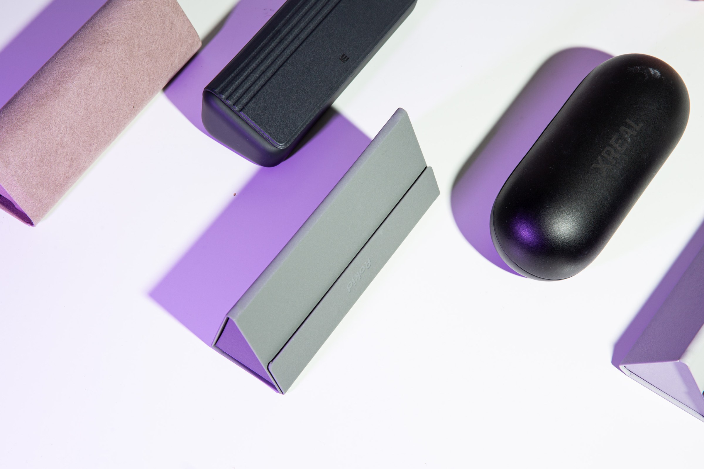 Cases for various smart glasses lined up.