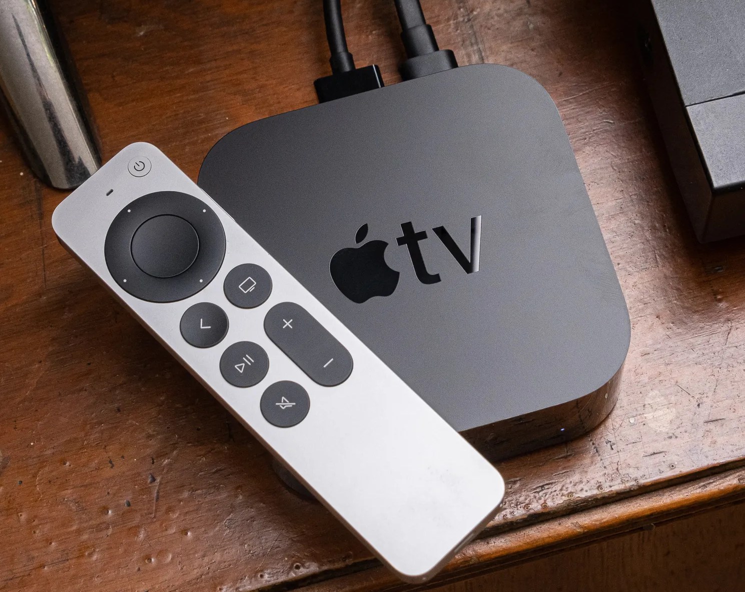 A photo of an Apple TV 4K on a TV stand.