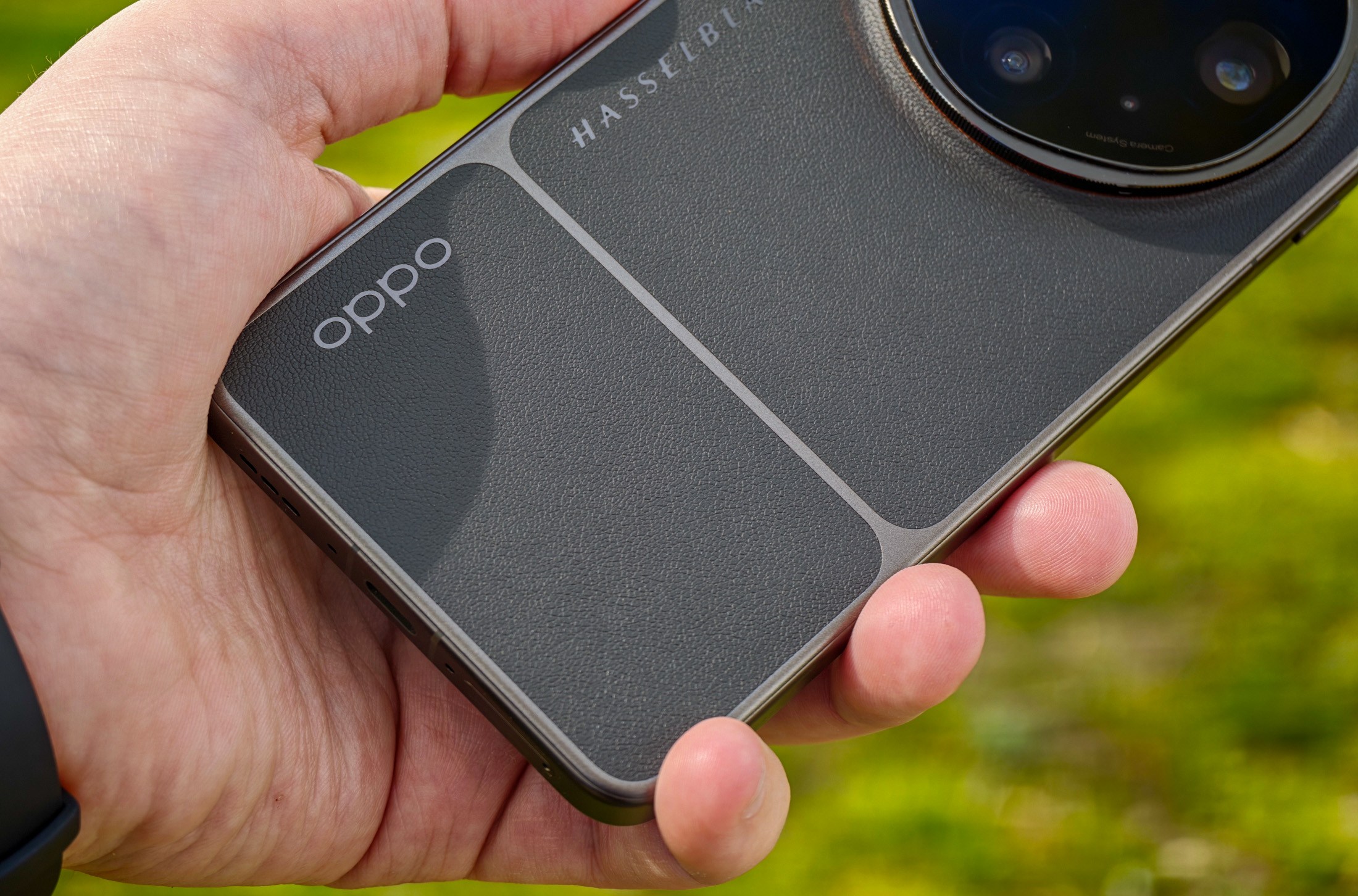 Photo of Oppo Find X9 Ultra held in someone’s hand, showing the Oppo logo