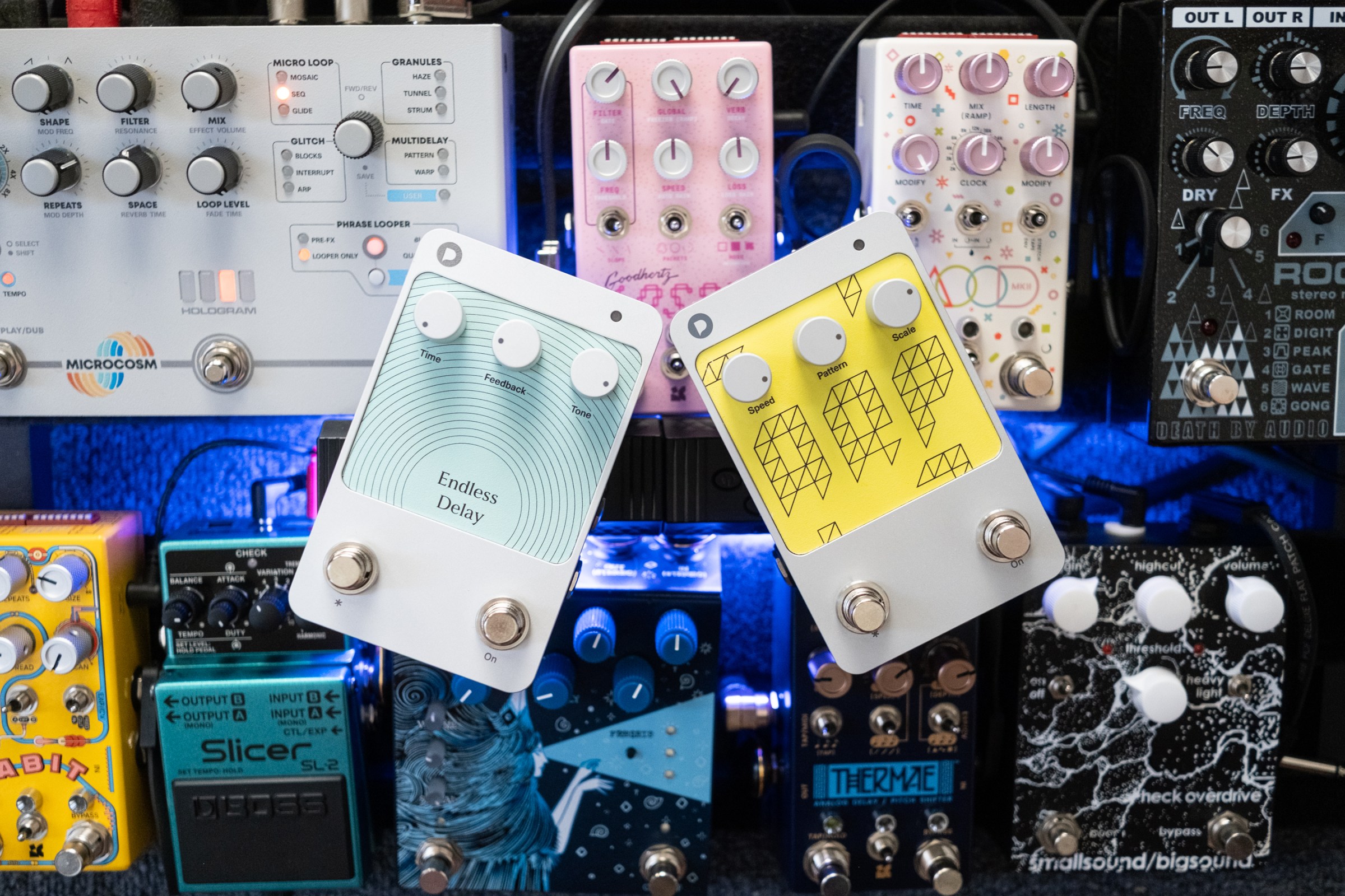 Two Polyend Endless guitar pedals in a wide shot on top of a pedalboard.
