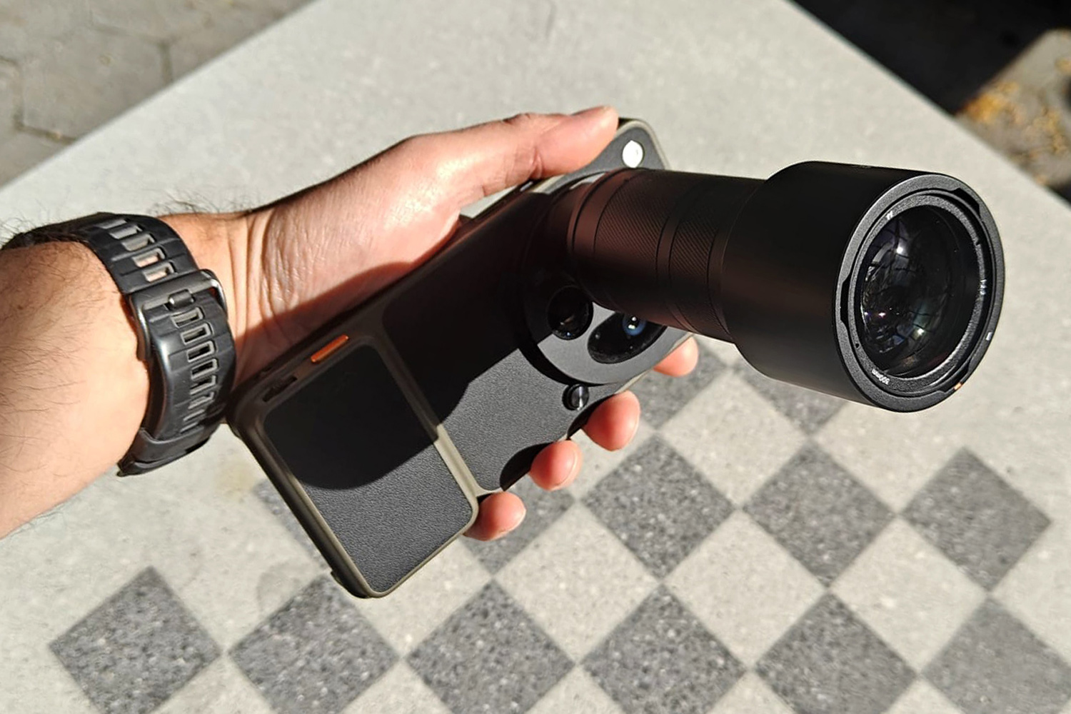 Oppo Hasselblad lens extender closeup in hand