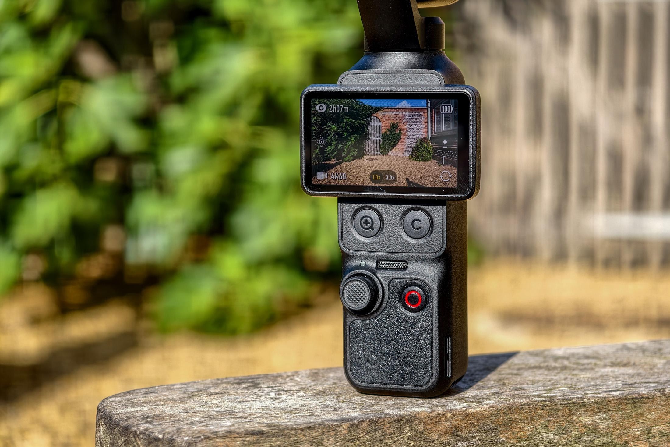 Photo of DJI Osmo Pocket 4P showing the controls and the screen recording a brick wall.