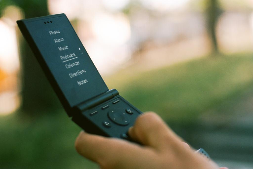 A Light Flip phone with the screen open in somebody's hand