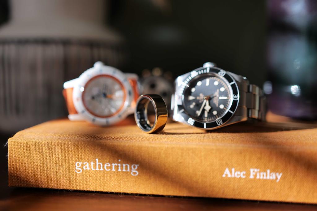 Smart ring and mechanical watches on a book